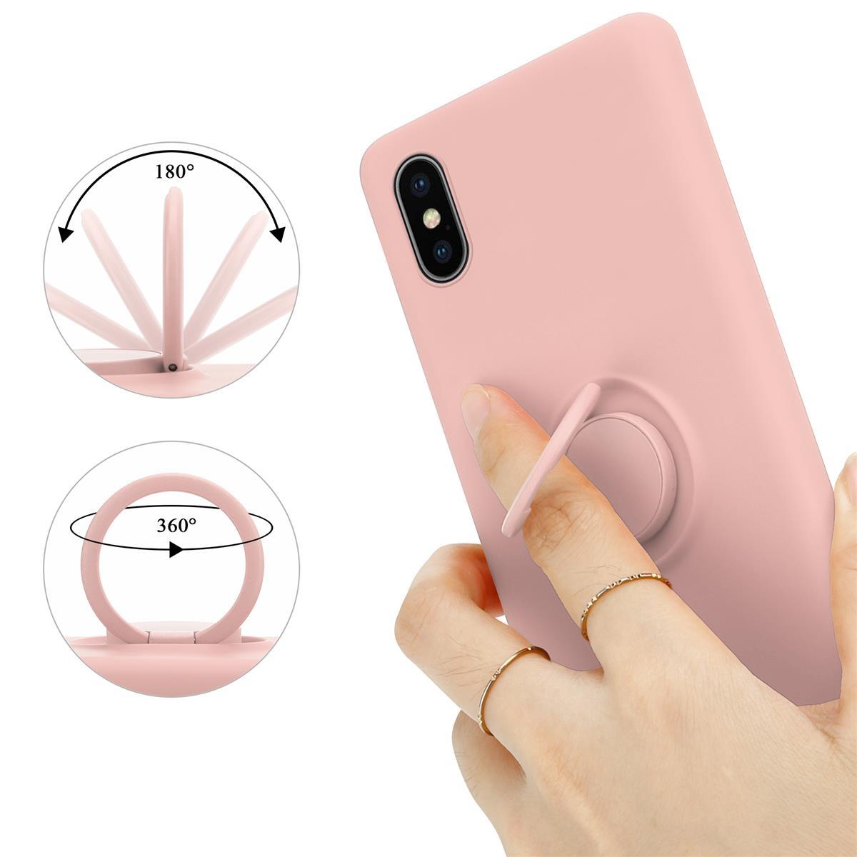 Custodia rosa, l'anello ruota di 180 e 360 gradi. Mano che tiene il telefono con anello.