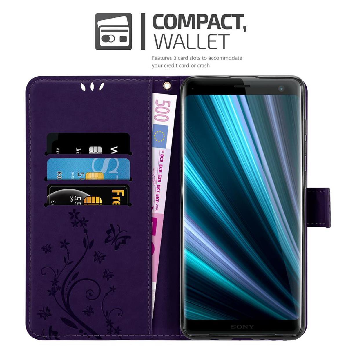 Una custodia per telefono viola con carte e denaro. Un telefono è all'interno.