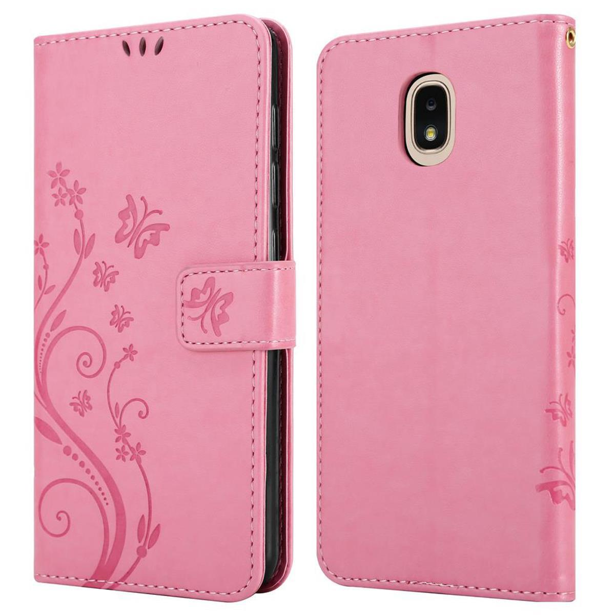 Una custodia per telefono rosa è aperta, mostrando un telefono, con un design floreale e una chiusura magnetica.