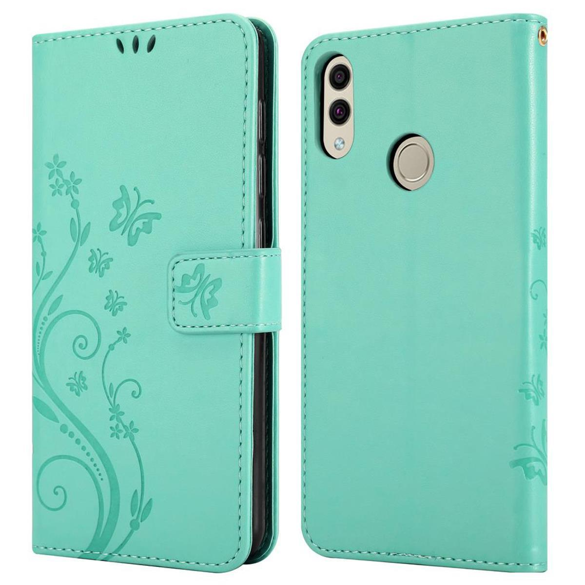Una custodia a portafoglio verde menta aperta e chiusa, che mostra un design floreale e una chiusura magnetica.