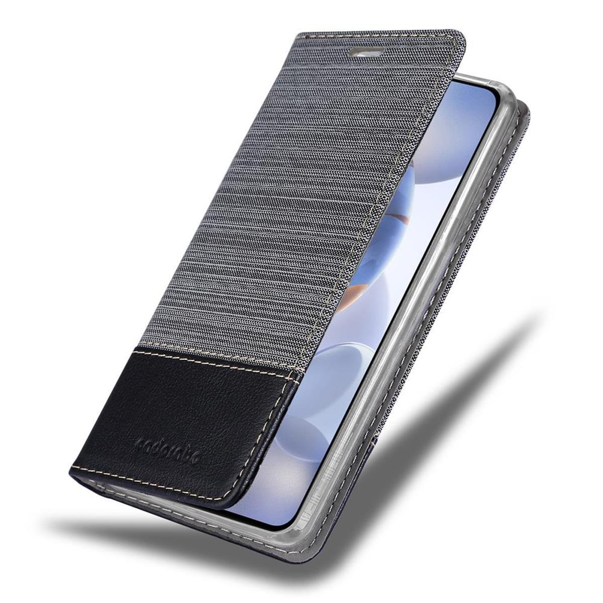 Ein Telefon in einer Hülle mit schwarzem Leder und grauem Stoff.