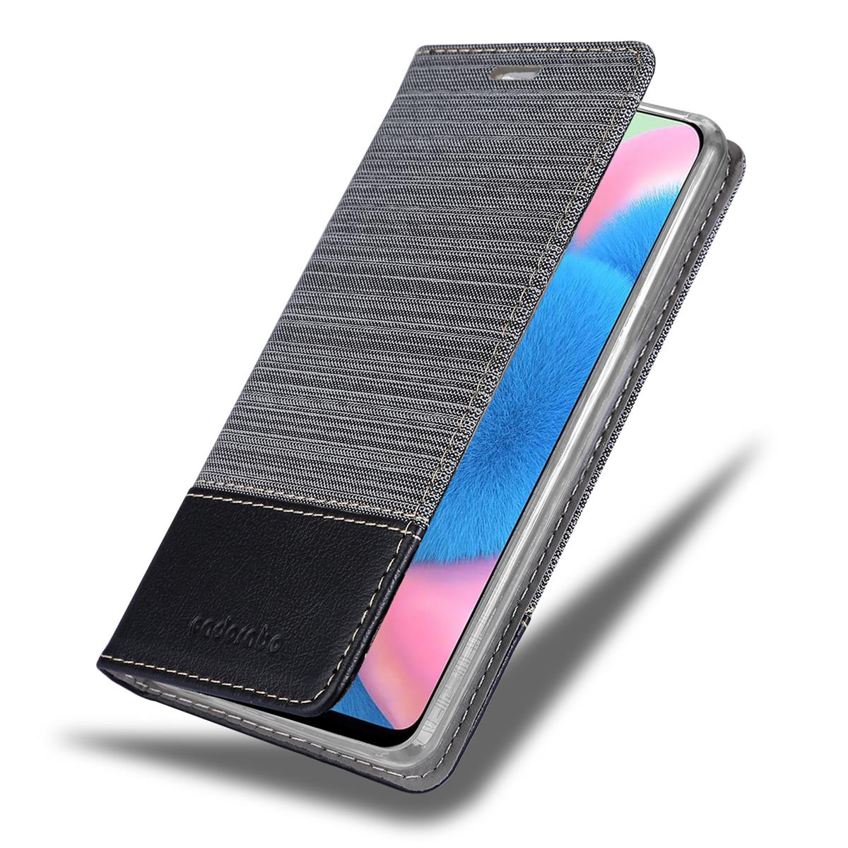 Handyhülle offen. Jeans- und schwarzer Bezug. Telefonbildschirm sichtbar. Weißer Hintergrund.