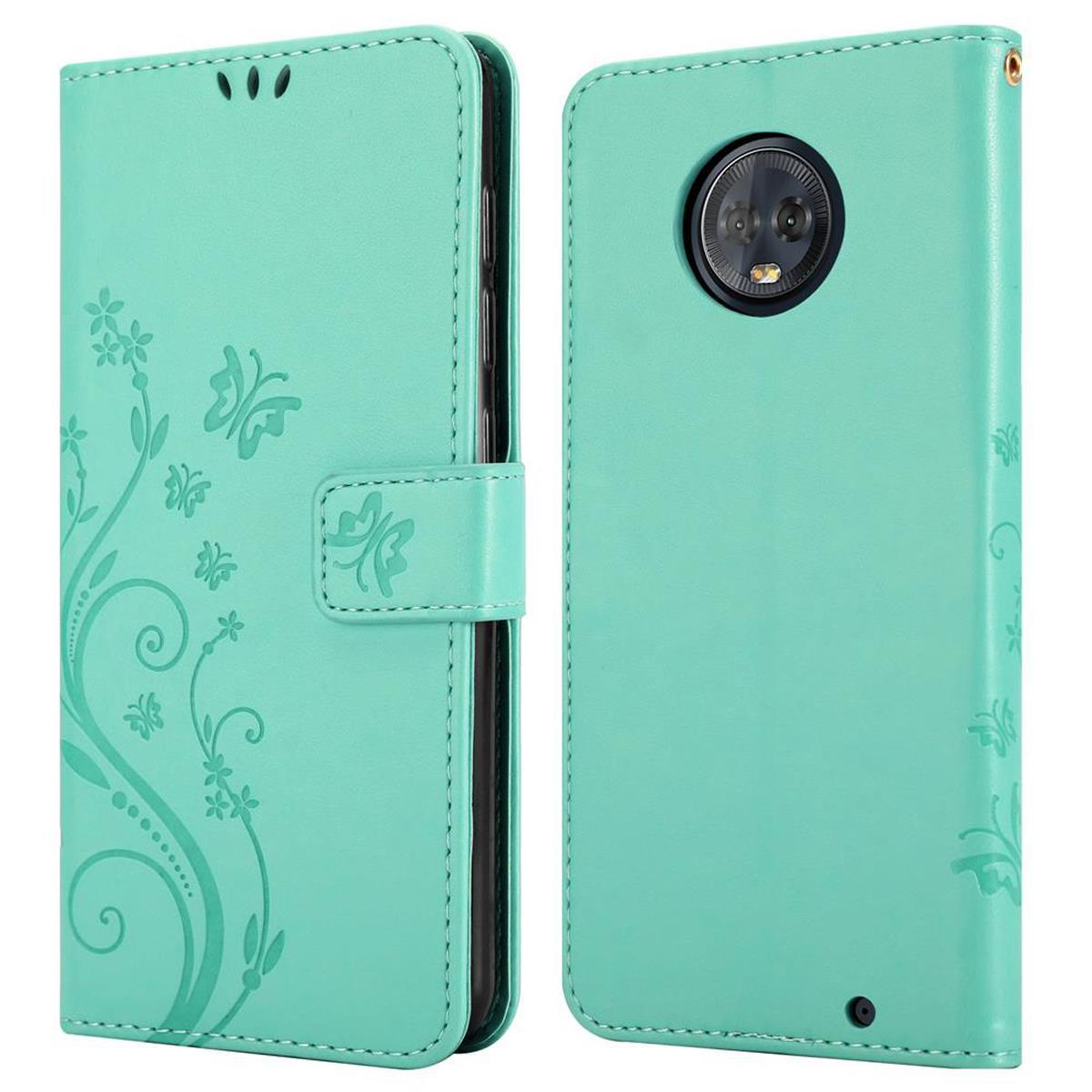 Una custodia per telefono turchese con un design a farfalla e floreale, aperta e chiusa, con chiusura a bottone.