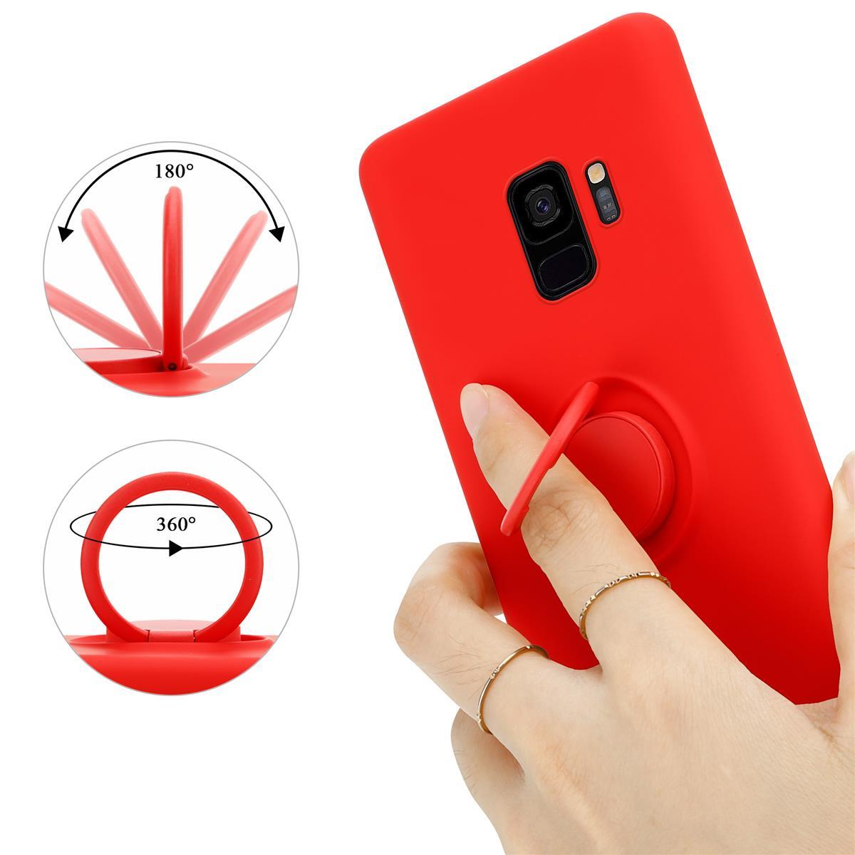 Una custodia rossa per telefono con un cavalletto. C'è un dito nell'anello.