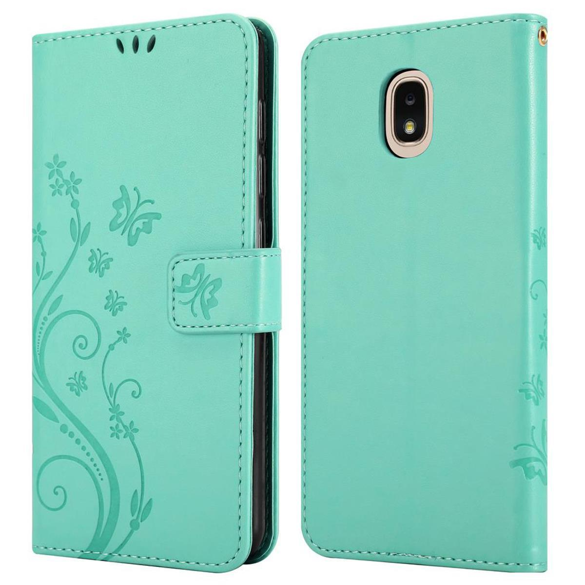 Custodia per telefono verde menta. La custodia è aperta. Lo sfondo ha un design floreale.