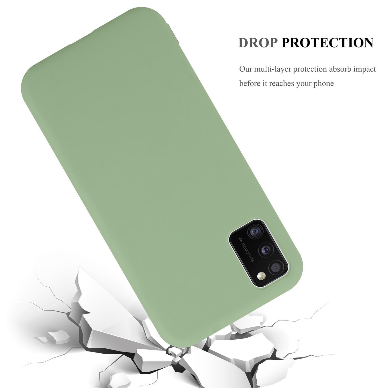 Grüne Handyhülle mit schwarzem Kameraausschnitt, Risse am Boden. Text "DROP PROTECTION".