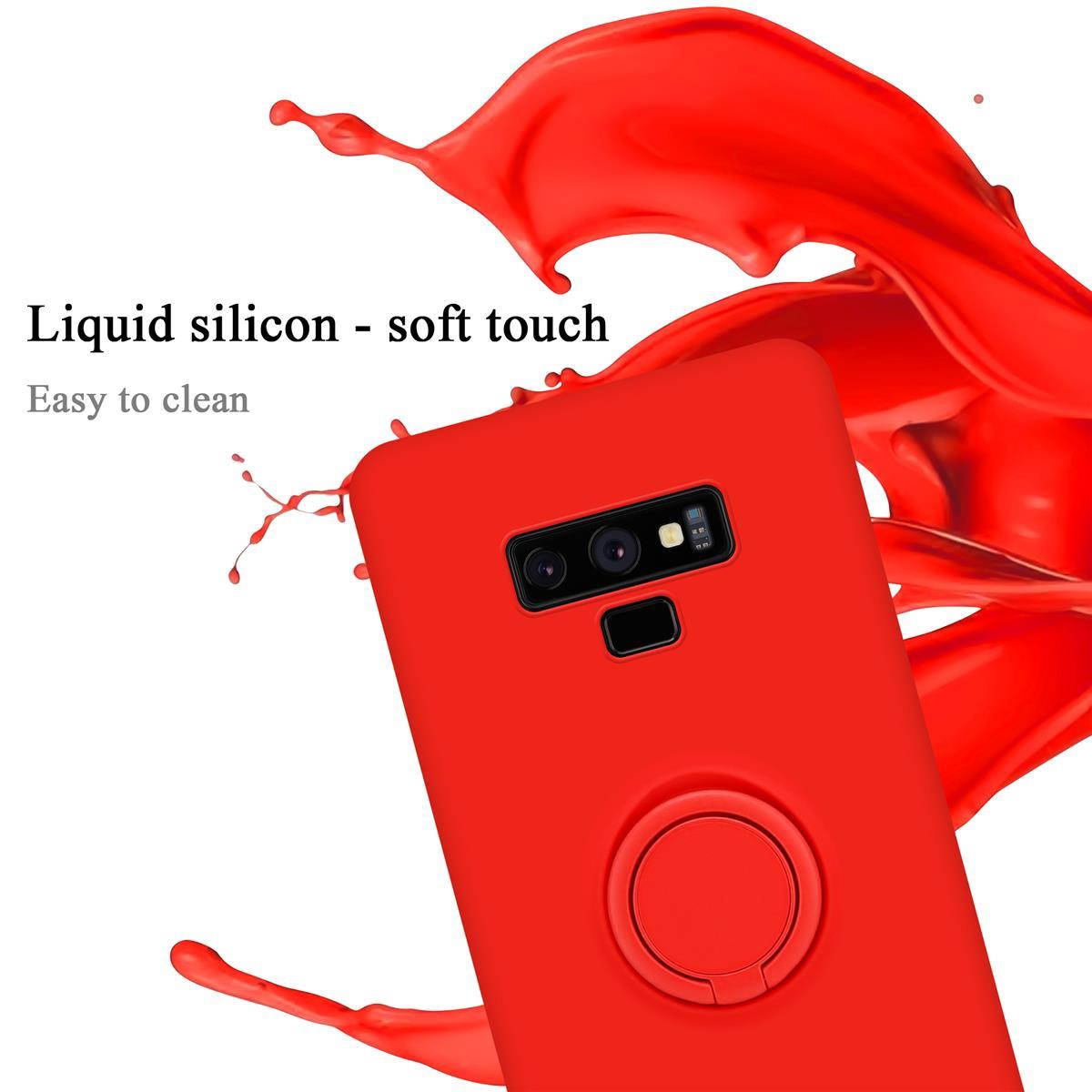 Custodia per telefono rossa con supporto ad anello. Schizzo di liquido nero sullo sfondo.