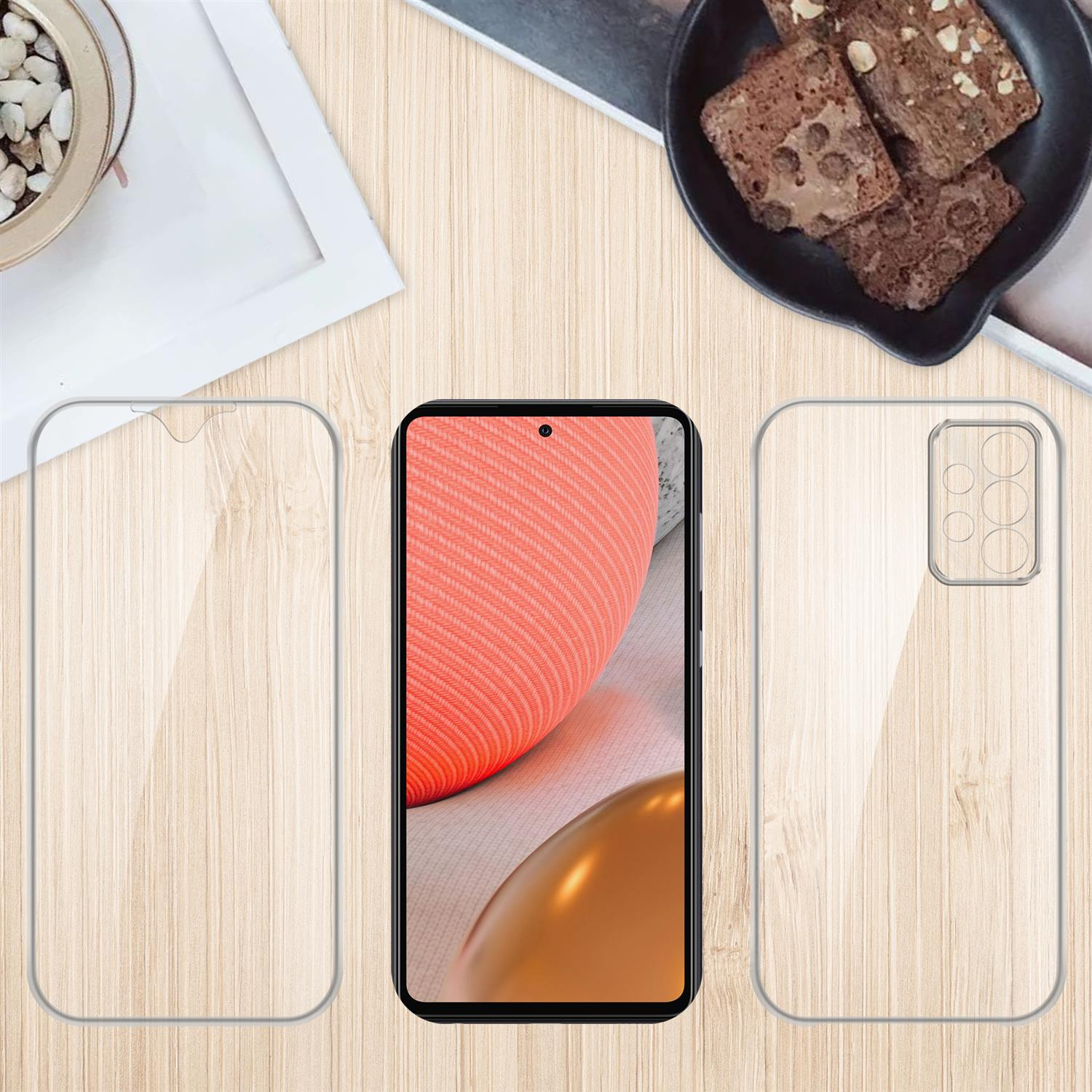 Un telefono con una protezione per lo schermo e una custodia, con uno snack e decorazioni su un tavolo di legno.