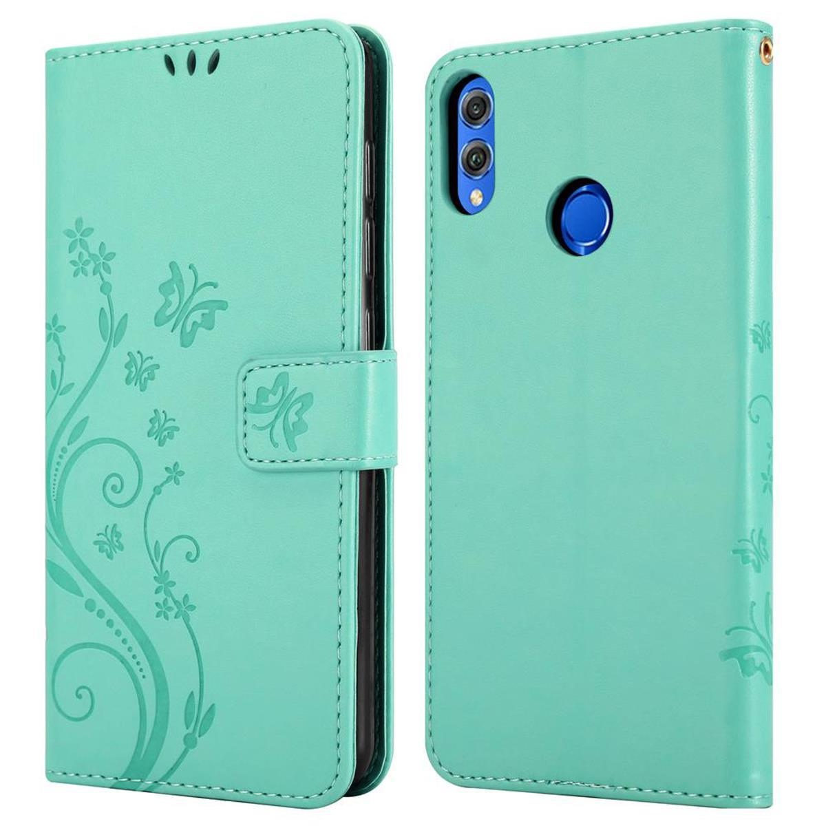 Una custodia per telefono color turchese, aperta e chiusa, con un design floreale. Sono presenti fiori e farfalle.