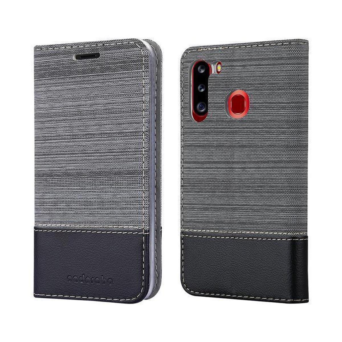 Custodia per telefono grigia e nera, aperta e chiusa. Fondo in pelle nera, tessuto grigio con cuciture.