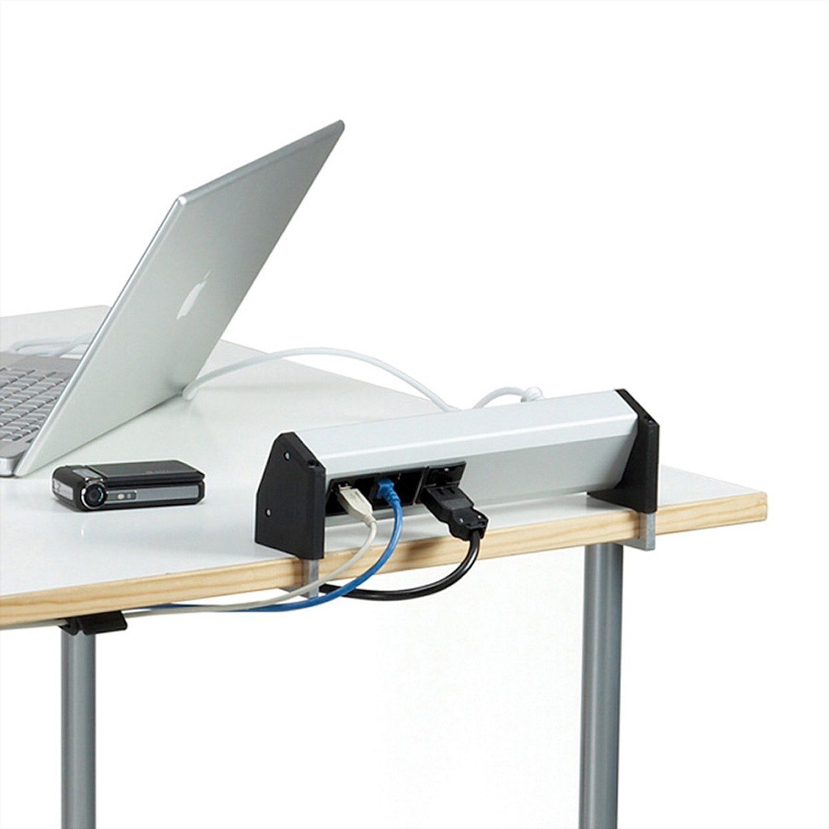 Laptop, telefon i listwa zasilająca na białym biurku, wszystko na białym tle.