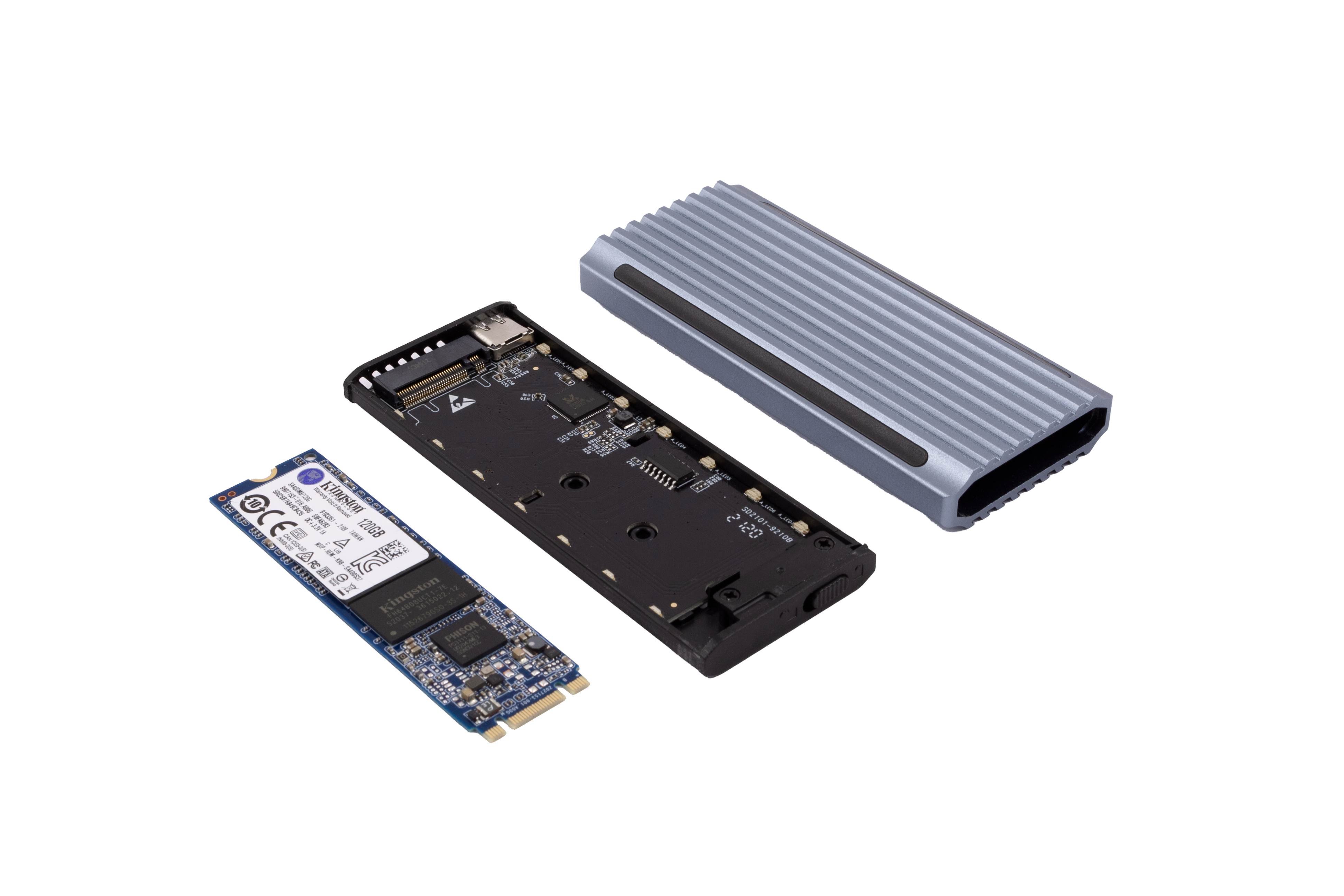 SSD desmontada, con carcasa plateada sobre negro. Se ven una tarjeta SSD azul y una placa de circuito negro.