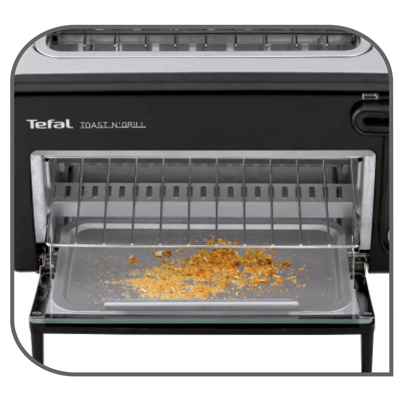 Schwarzer Toaster mit Tefal-Marke, Krümelschublade offen mit Krümeln.