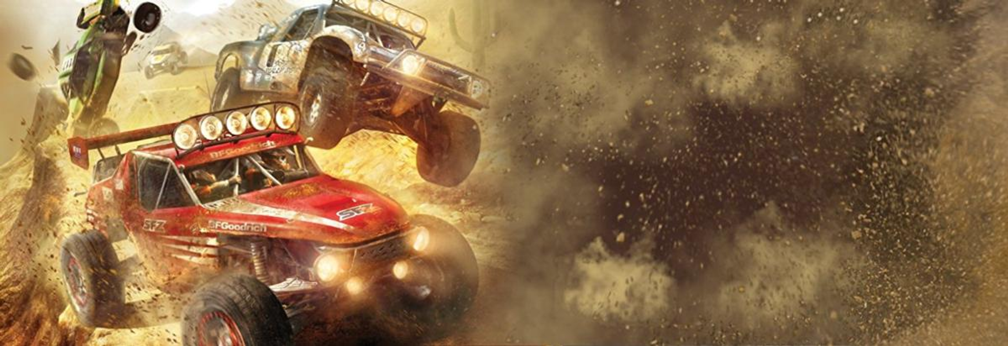 Obraz gry wideo z samochodami wyścigowymi skaczącymi w powietrzu, wzbijającymi kurz. Gra jest o wyścigach.