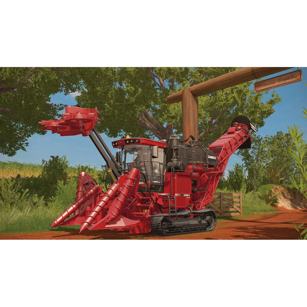 Grande mietitrebbia rossa in un campo. Cartello in legno con testo e alberi verdi sullo sfondo.