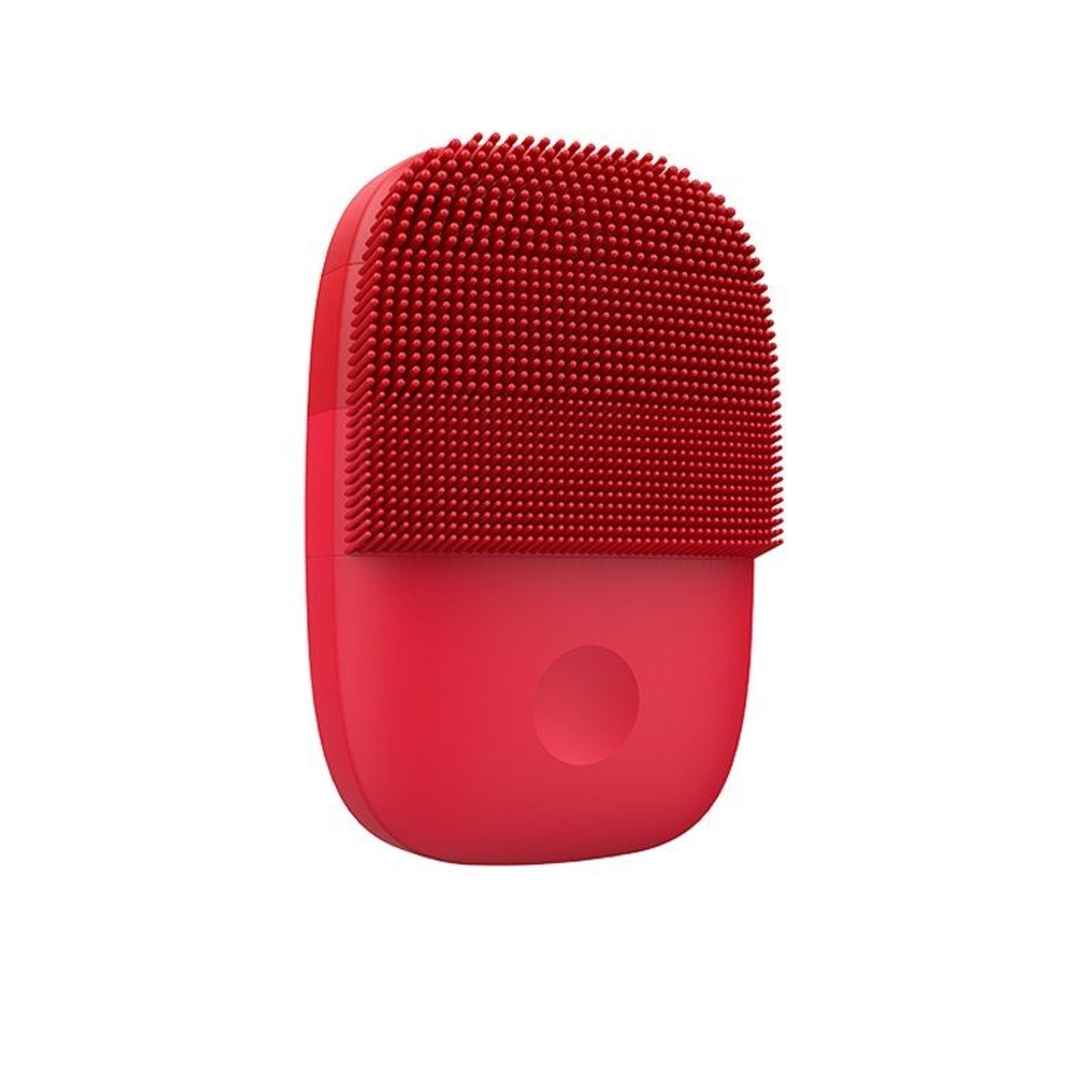 Cepillo de limpieza facial de silicona roja con forma redondeada y superficie texturizada.