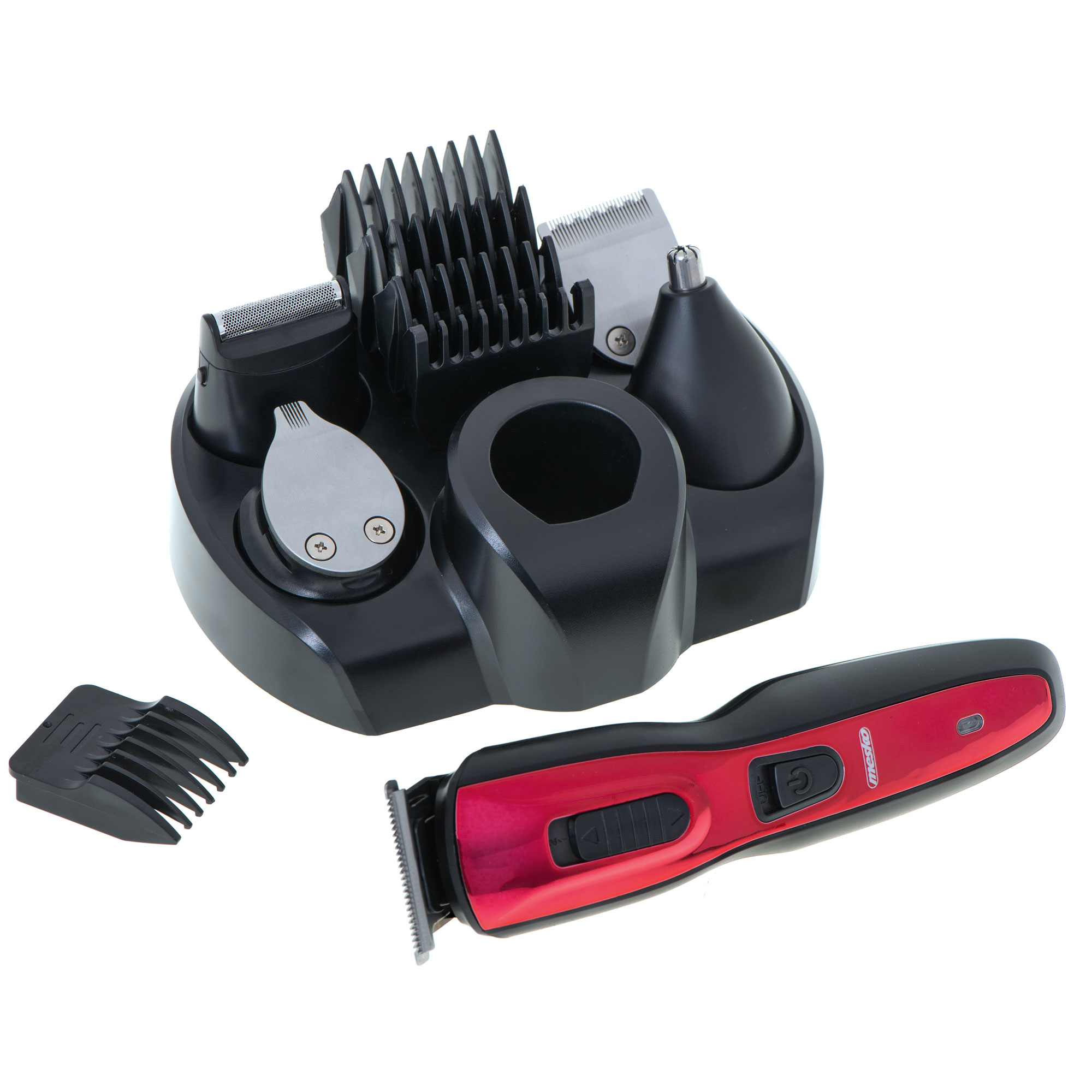 Kit de aseo múltiple con recortadora roja y negra y accesorios. Está sobre una superficie blanca.