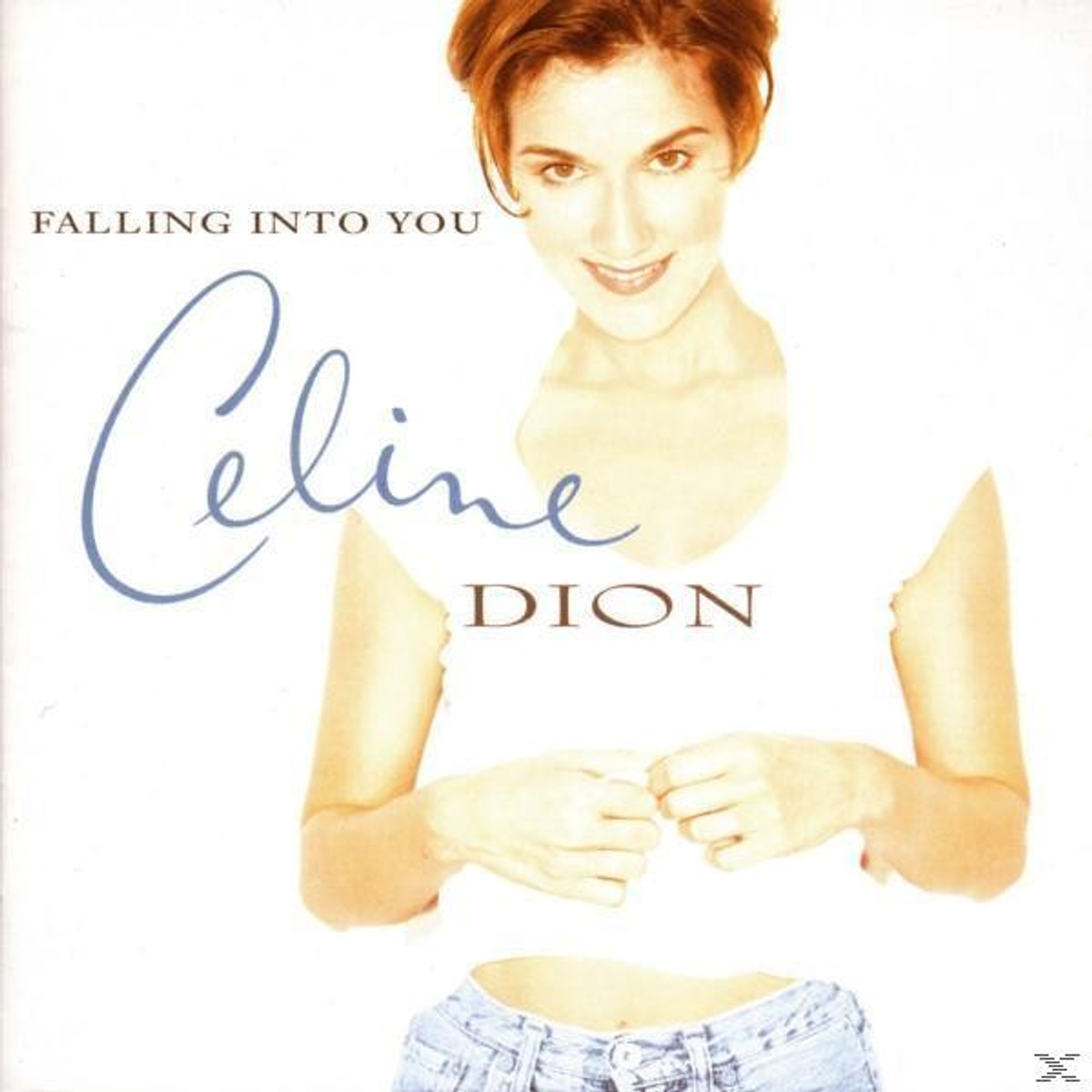 Celine Dion sulla copertina di un album. Top bianco, jeans e un viso sorridente.