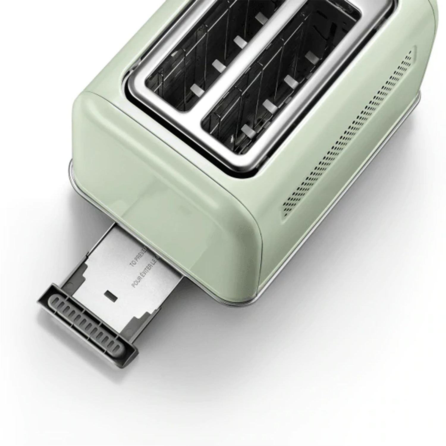 Miętowy toster z dwoma otworami. Tost jest częściowo wyrzucony z prawej strony.