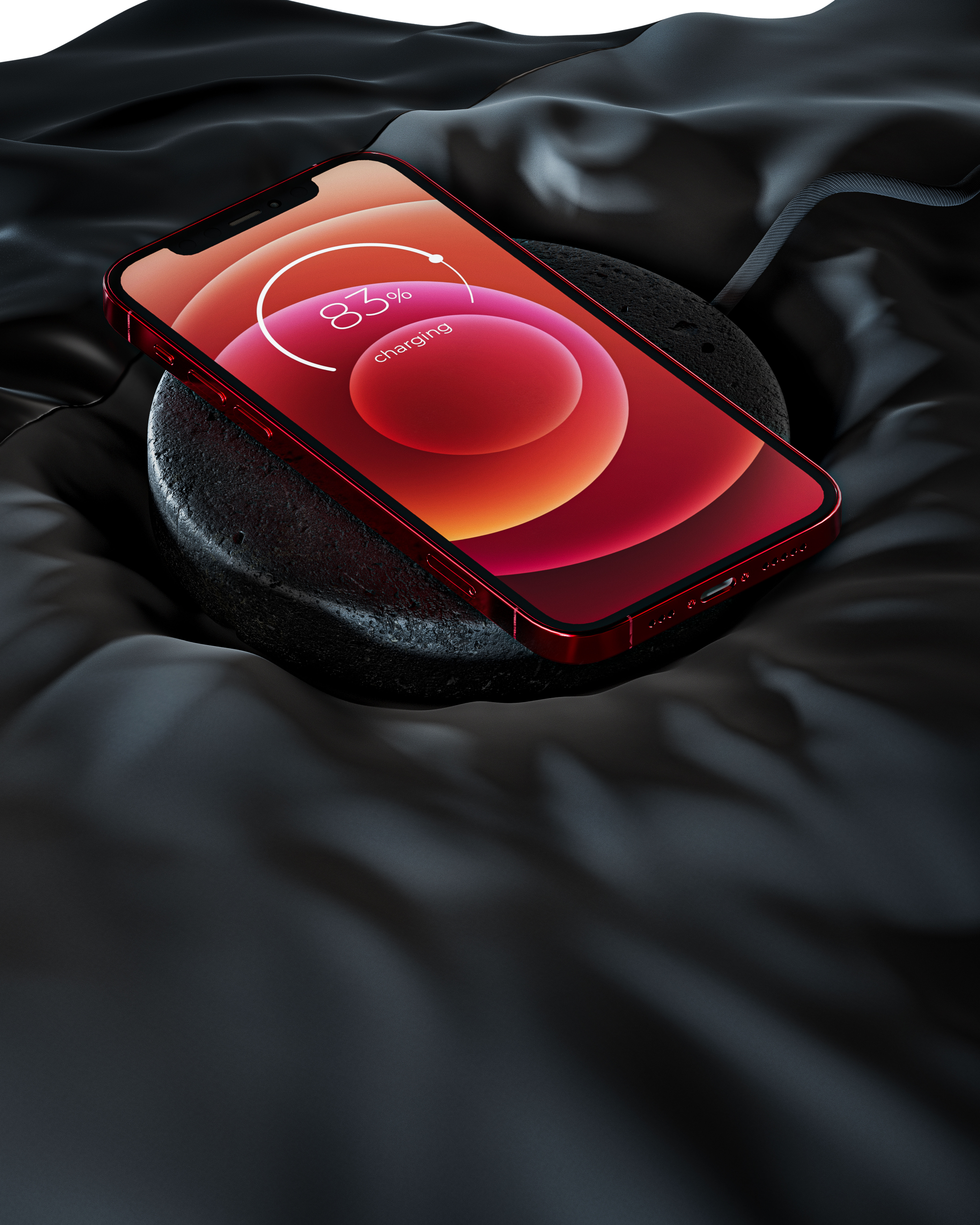 Rotes Telefon, das auf einer dunklen Oberfläche geladen wird, mit schwarzem Seidenstoff.