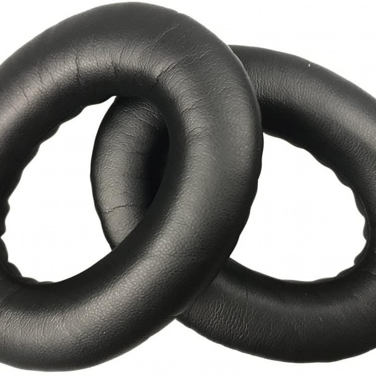 Dwie czarne, okrągłe nauszniki do słuchawek na białym tle.