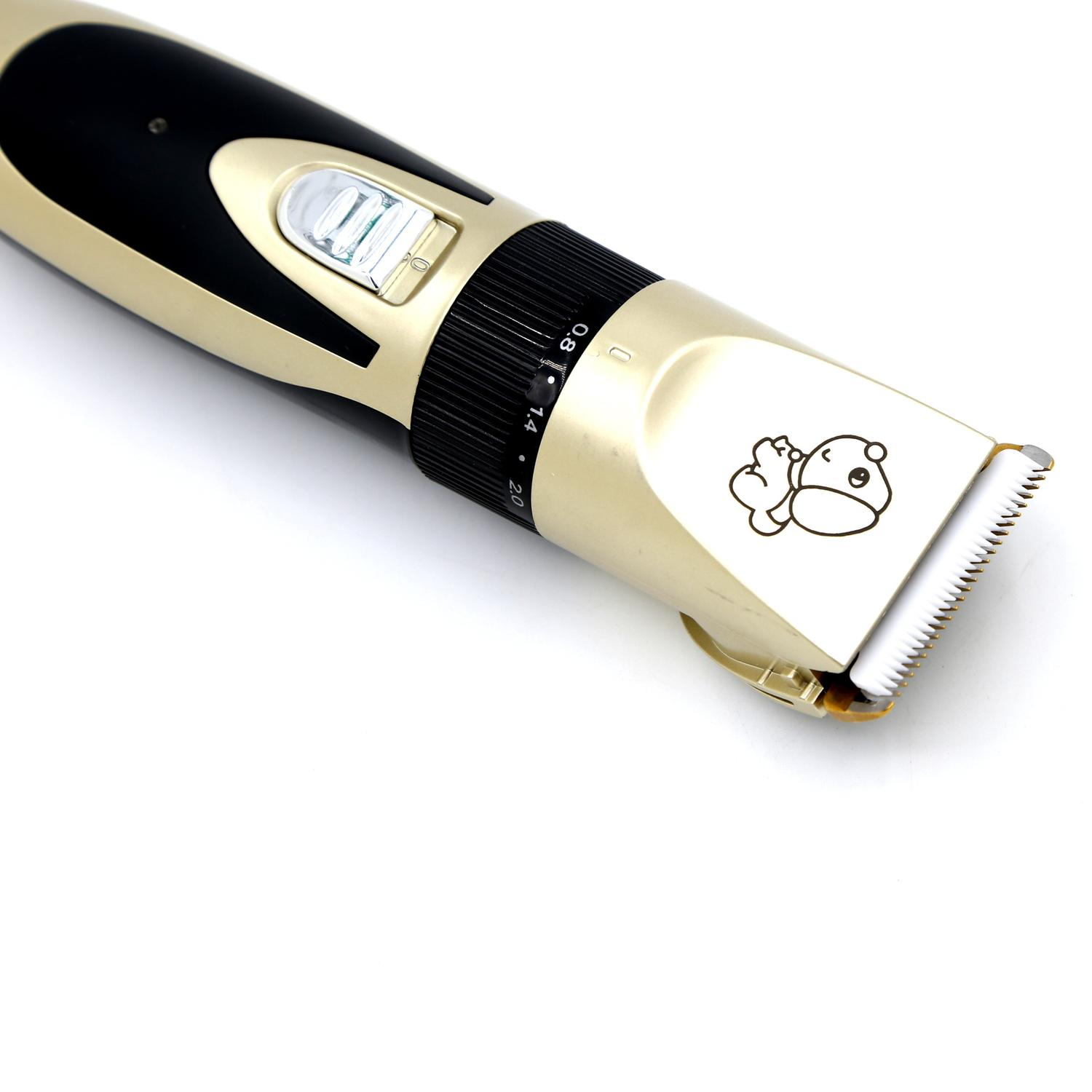 Złoto-czarna maszynka do włosów z kreskówką niedźwiedzia. Maszynka ma ostrze i pokrętło do regulacji długości.