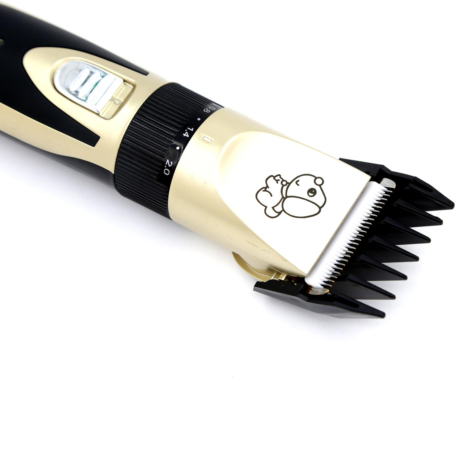 Elektryczna maszynka do włosów, czarna i złota, ze zdjęciem niedźwiedzia i pokrętłem, na białej powierzchni.