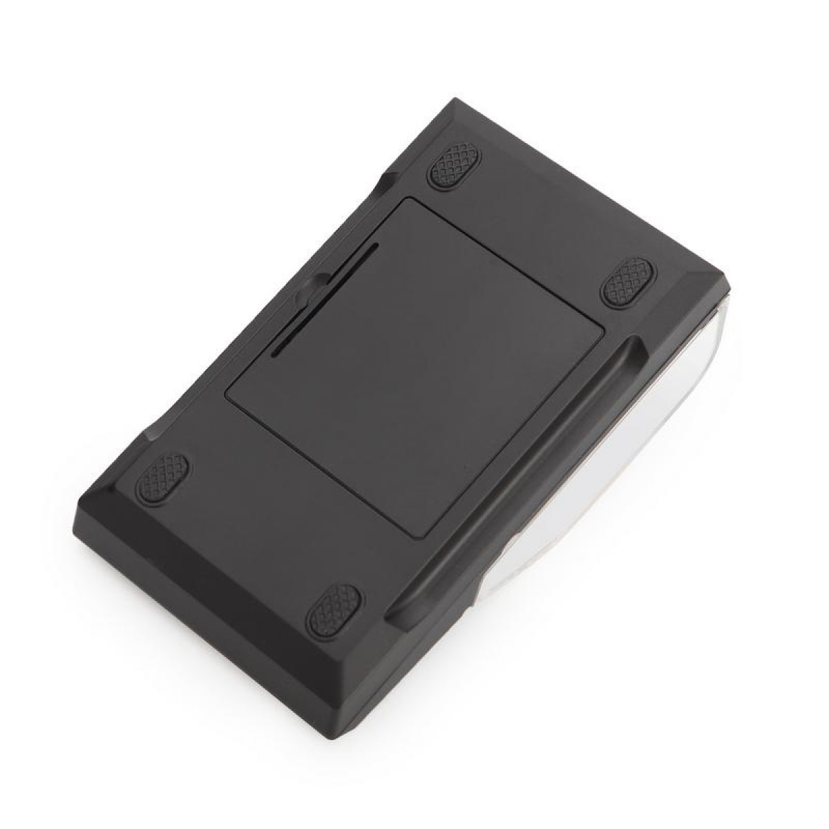 Czarne urządzenie elektroniczne z gumowymi nóżkami, tyłem do góry. Białe tło.