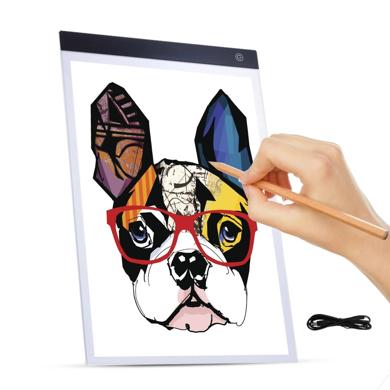 Ręka rysująca kolorowego psa na tablicy świetlnej. Widoczne czerwone okulary, ołówek i przewód.