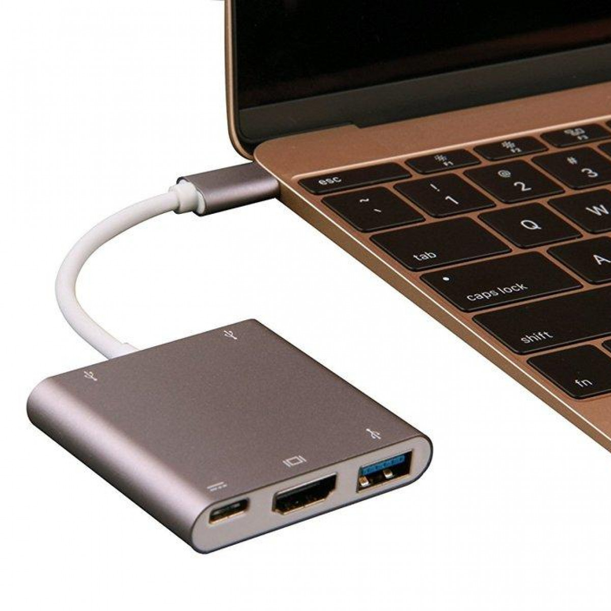 Srebrny hub podłączony do złotego laptopa białym kablem. Posiada porty USB i HDMI.