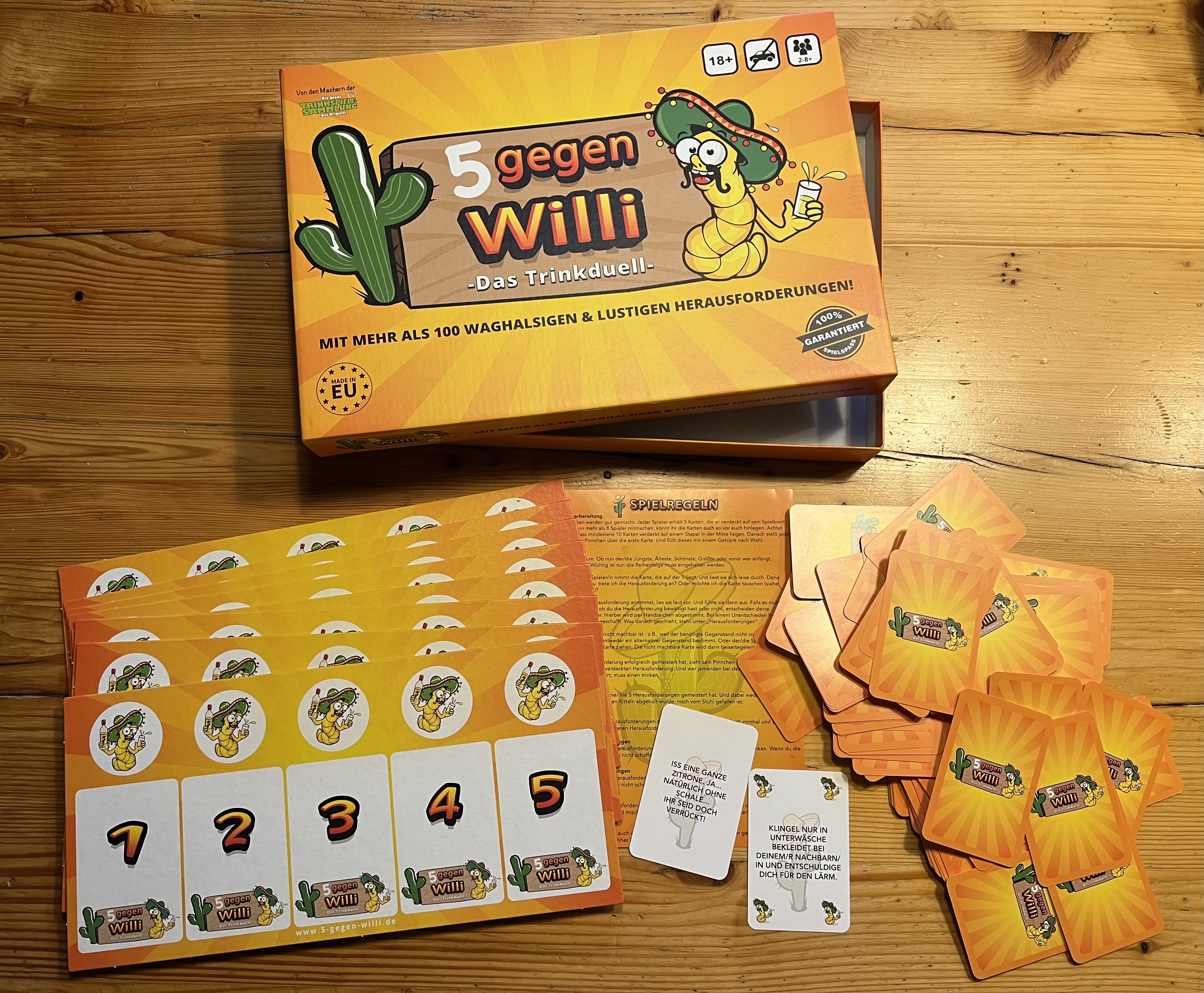 Brettspiel mit Karten und Anleitungen. Box zeigt '5 gegen Willi' mit Cartoonfigur.