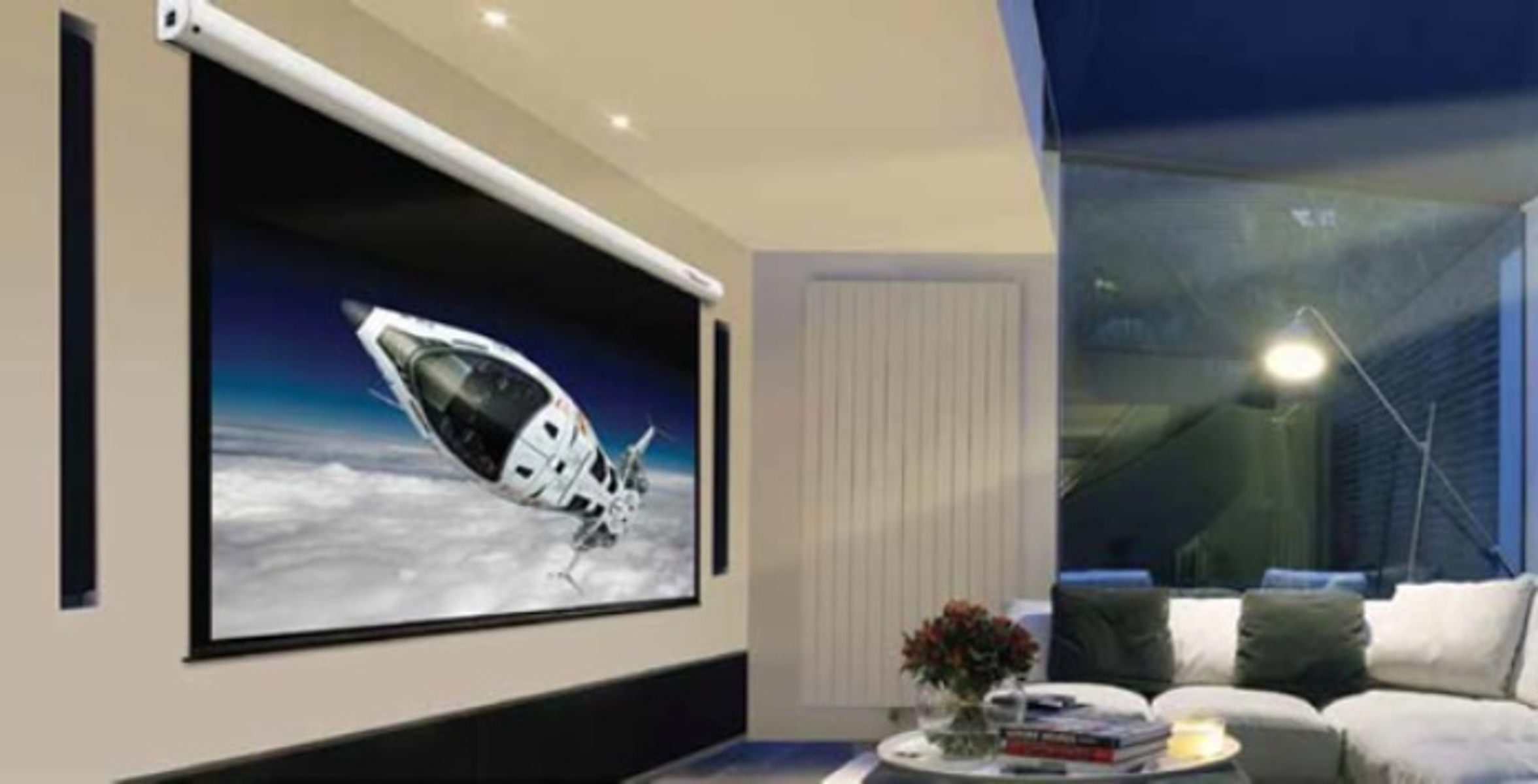 Una pantalla grande muestra una nave espacial en el espacio. Un sofá blanco frente a la pantalla.