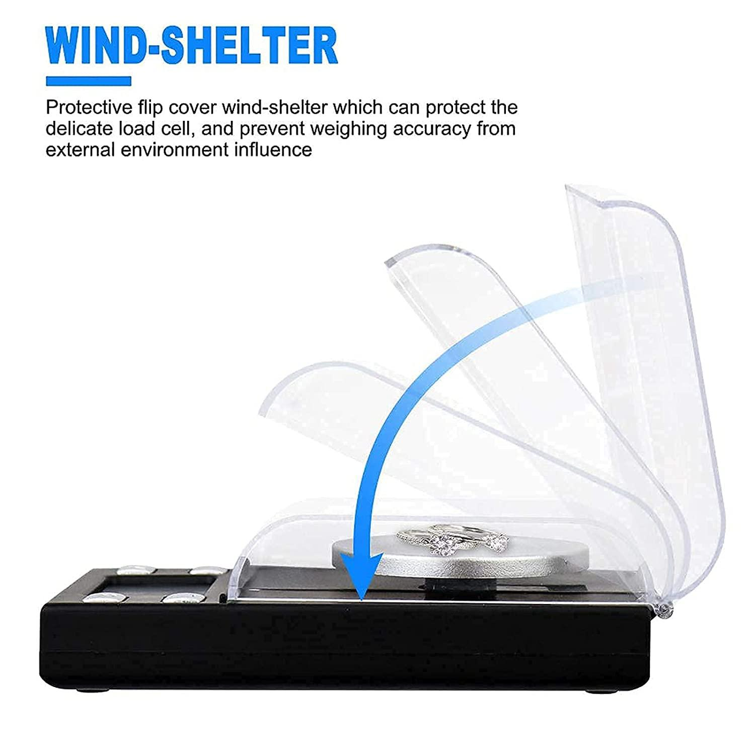 Mała waga z przezroczystą osłoną chroniącą pierścionek. Osłona jest podnoszona.