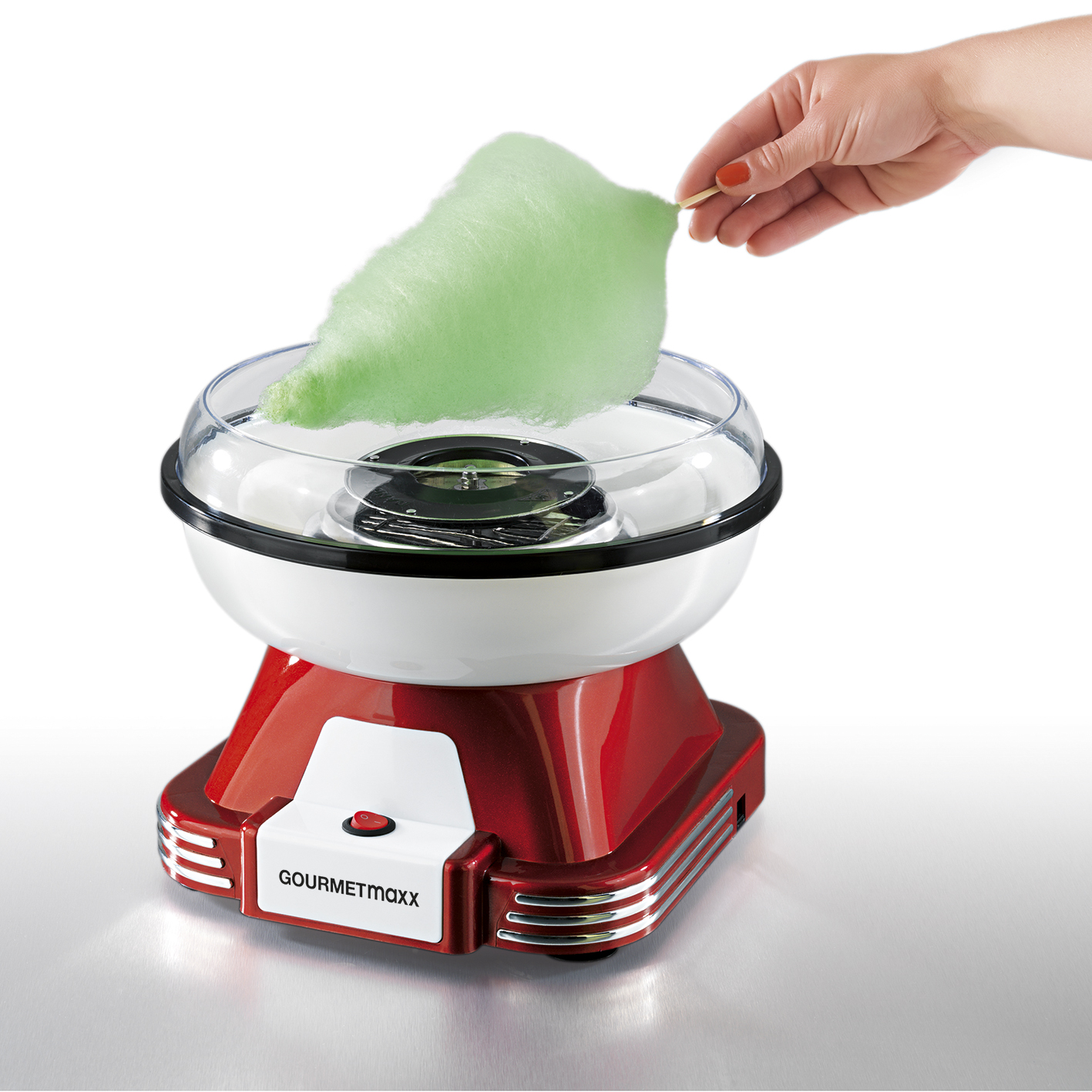 Eine rot-weiße Zuckerwattemaschine mit einer grünen Zuckerwolke.