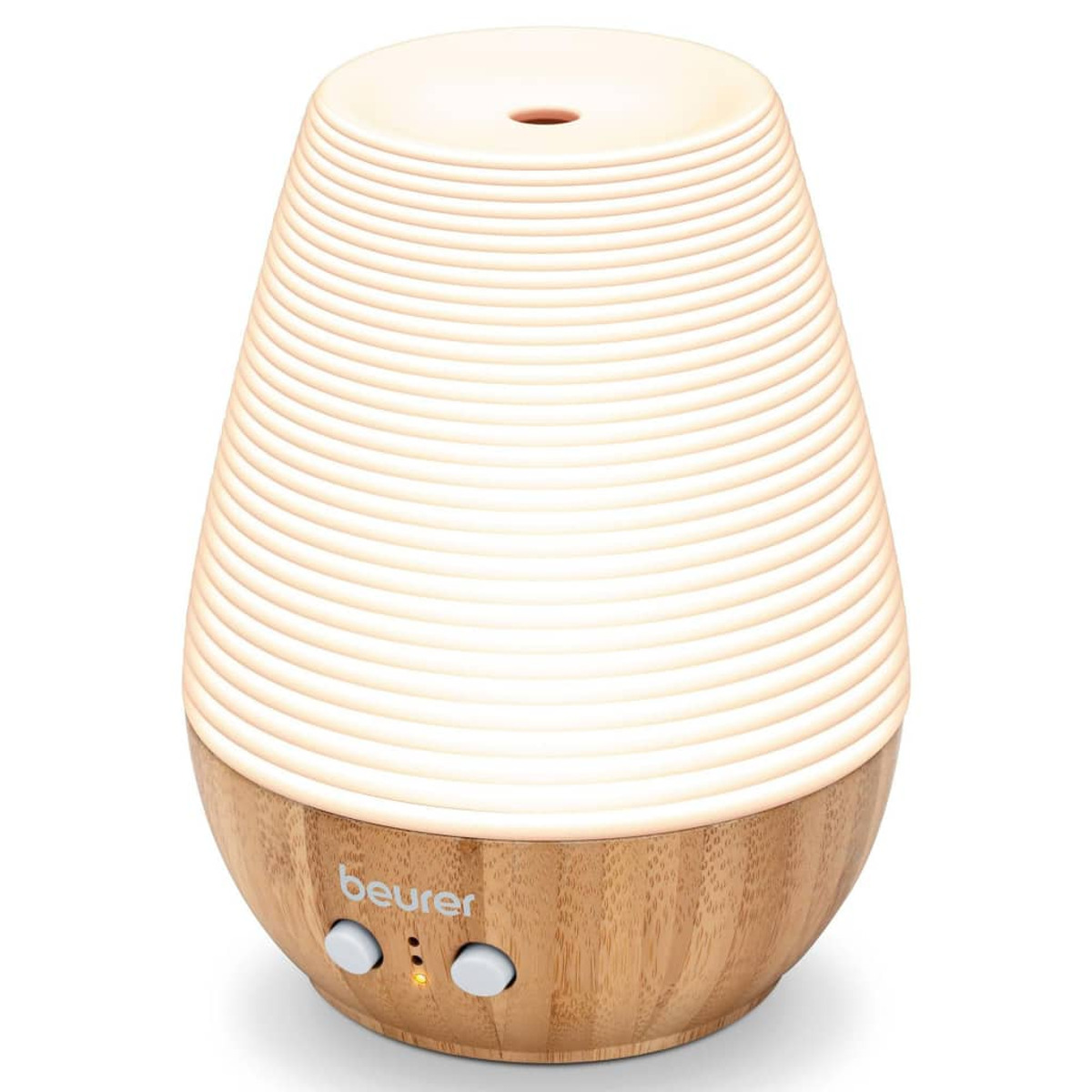 Weißer und holzfarbener Aromadiffusor, mit Licht, das von ihm ausgeht.