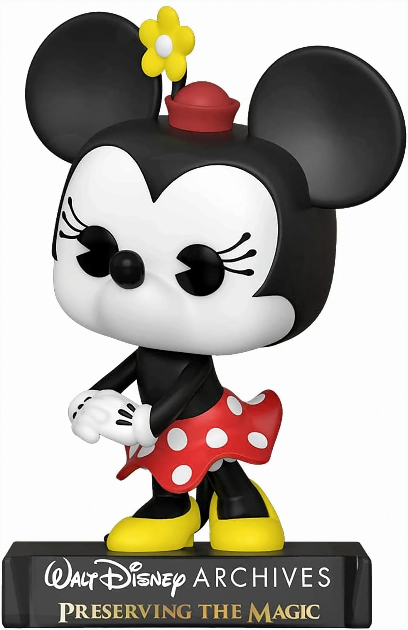 Minnie Mouse Figur in rotem gepunkteten Rock, auf Sockel stehend.