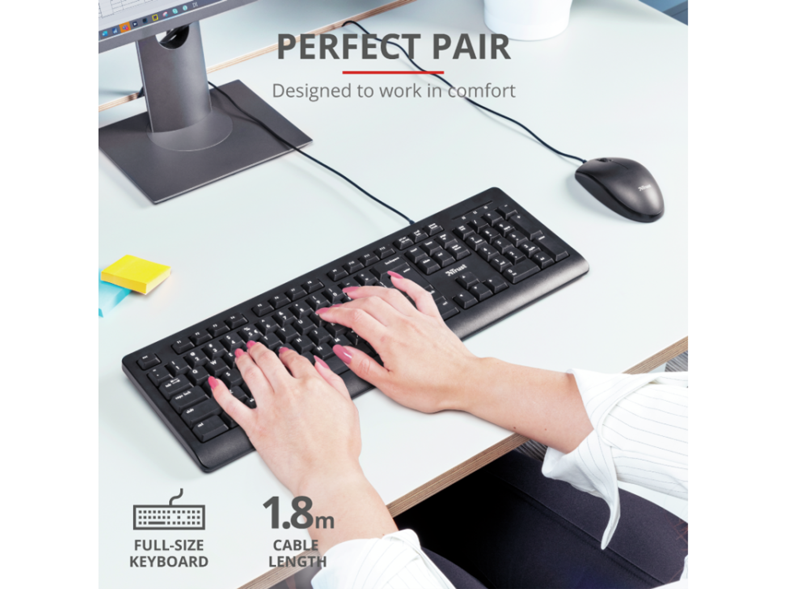 Ręce piszące na klawiaturze, czarna mysz. Białe biurko, czarna klawiatura.