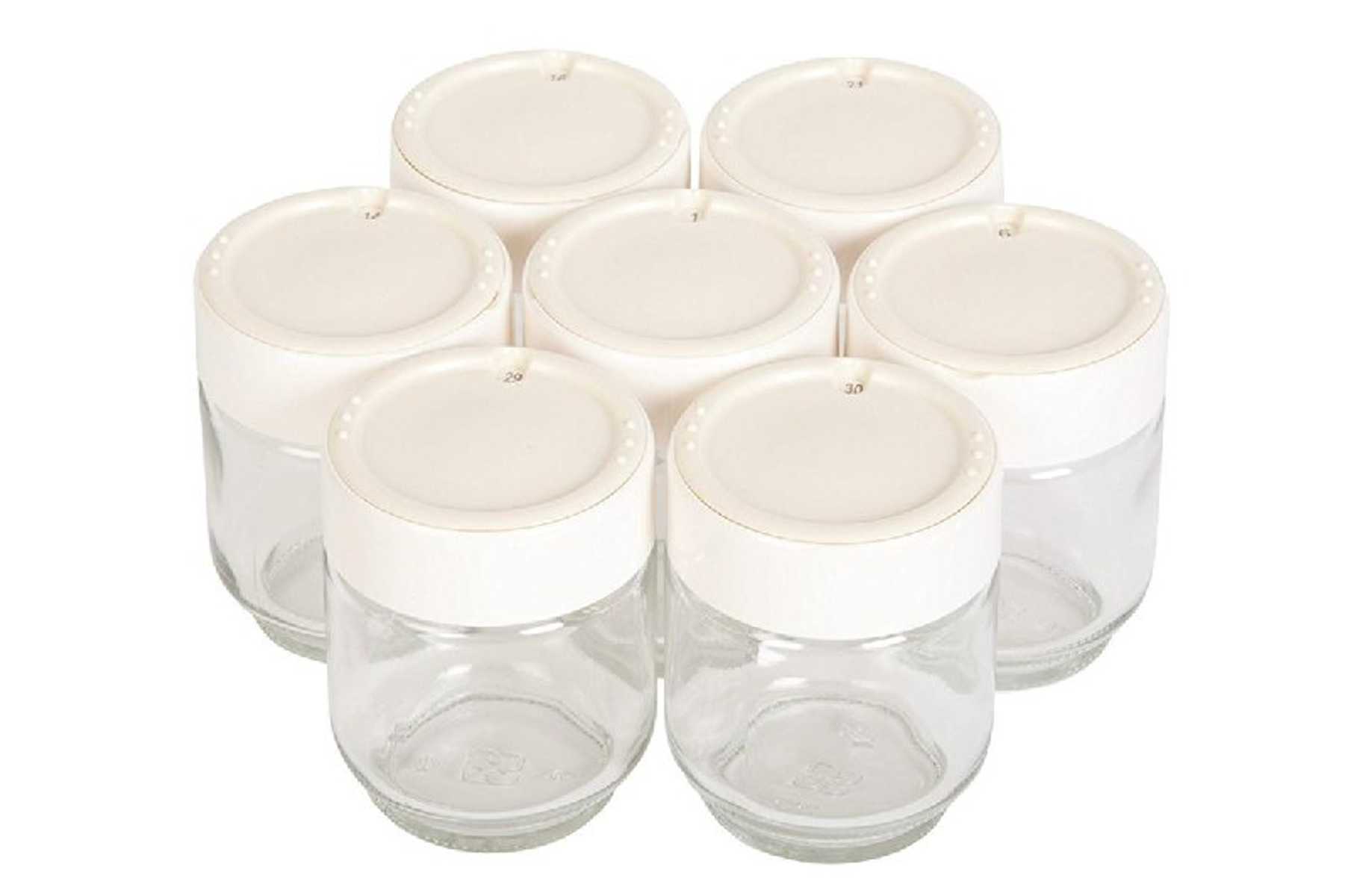 Zestaw siedmiu szklanych słoików z białymi pokrywkami. Ułożone są w okrąg.