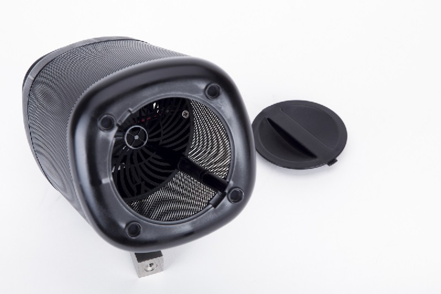Vista inferior de un purificador de aire negro. Rejilla y ventilador interno visibles. Tapa negra a un lado.
