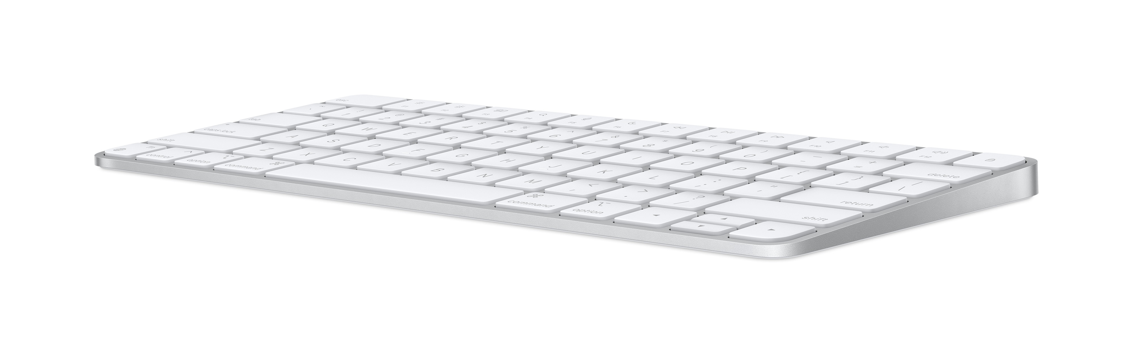 Un teclado de computadora blanco. Tiene teclas blancas y un borde plateado.