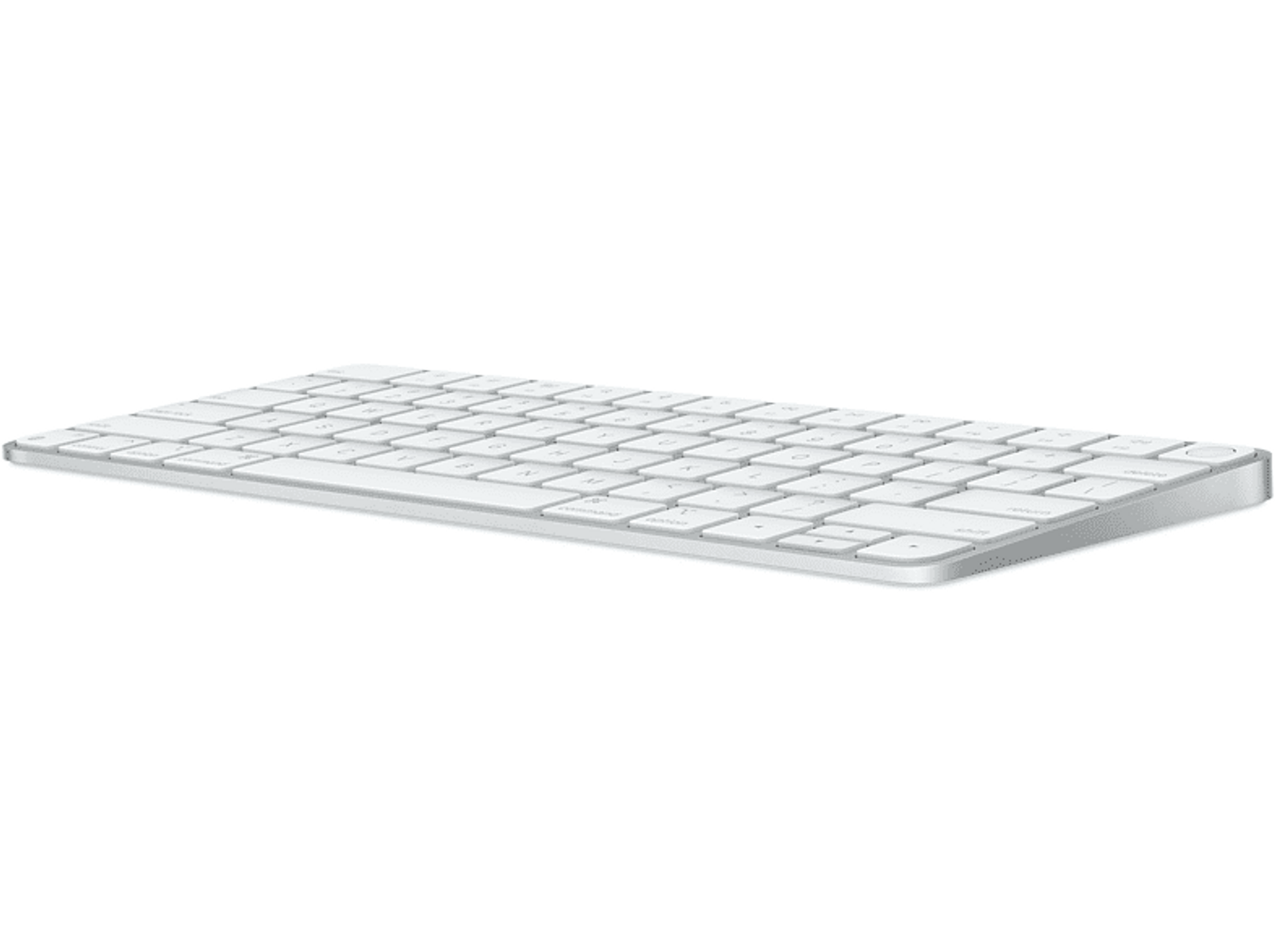 Teclado inalámbrico blanco sobre una superficie blanca. Fondo negro.