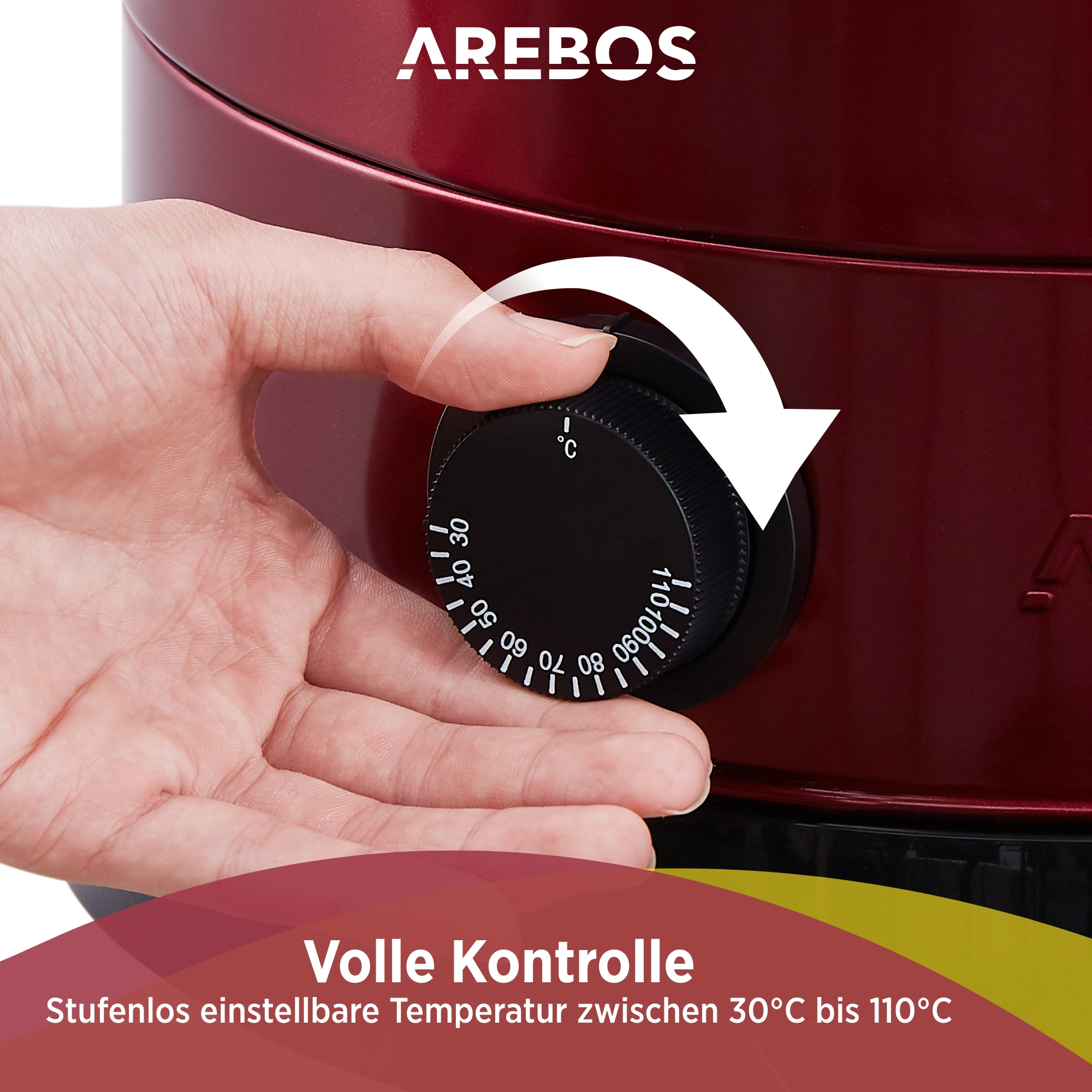 Eine Hand dreht einen Drehregler an einem roten Gerät, Temperaturregelung wird angezeigt.