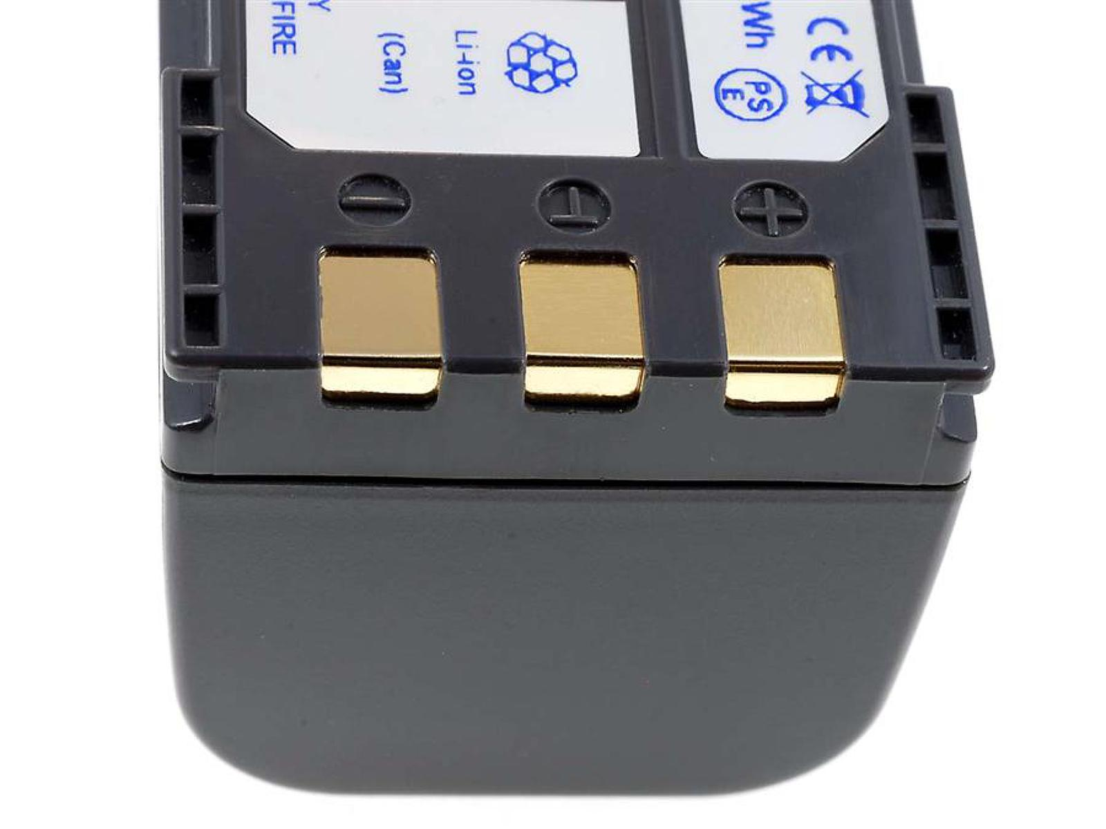 Nahaufnahme einer Batterie, die drei goldfarbene Kontaktpunkte auf einer grauen Oberfläche zeigt.