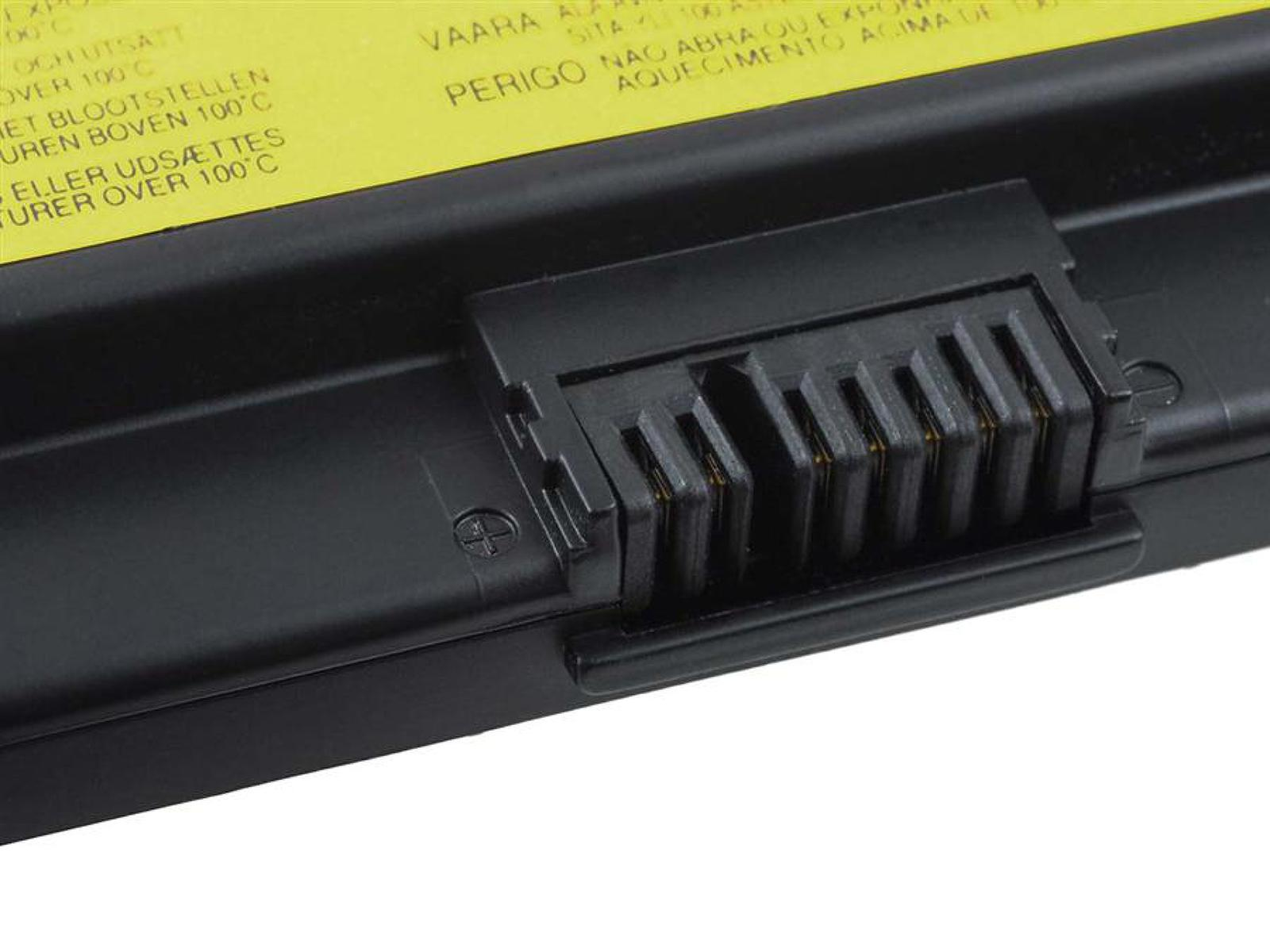 Primer plano del conector de la batería del portátil. Etiqueta amarilla con texto visible.