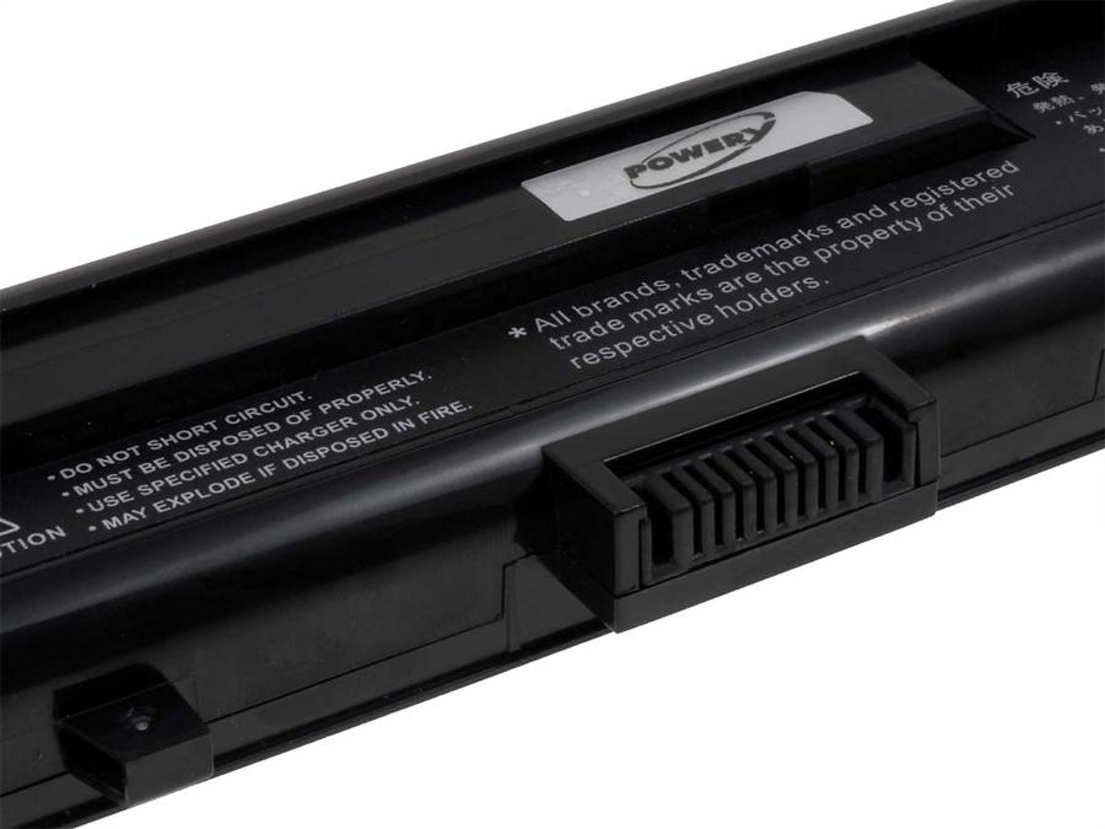 Batería negra de portátil con una etiqueta con advertencias y un conector.