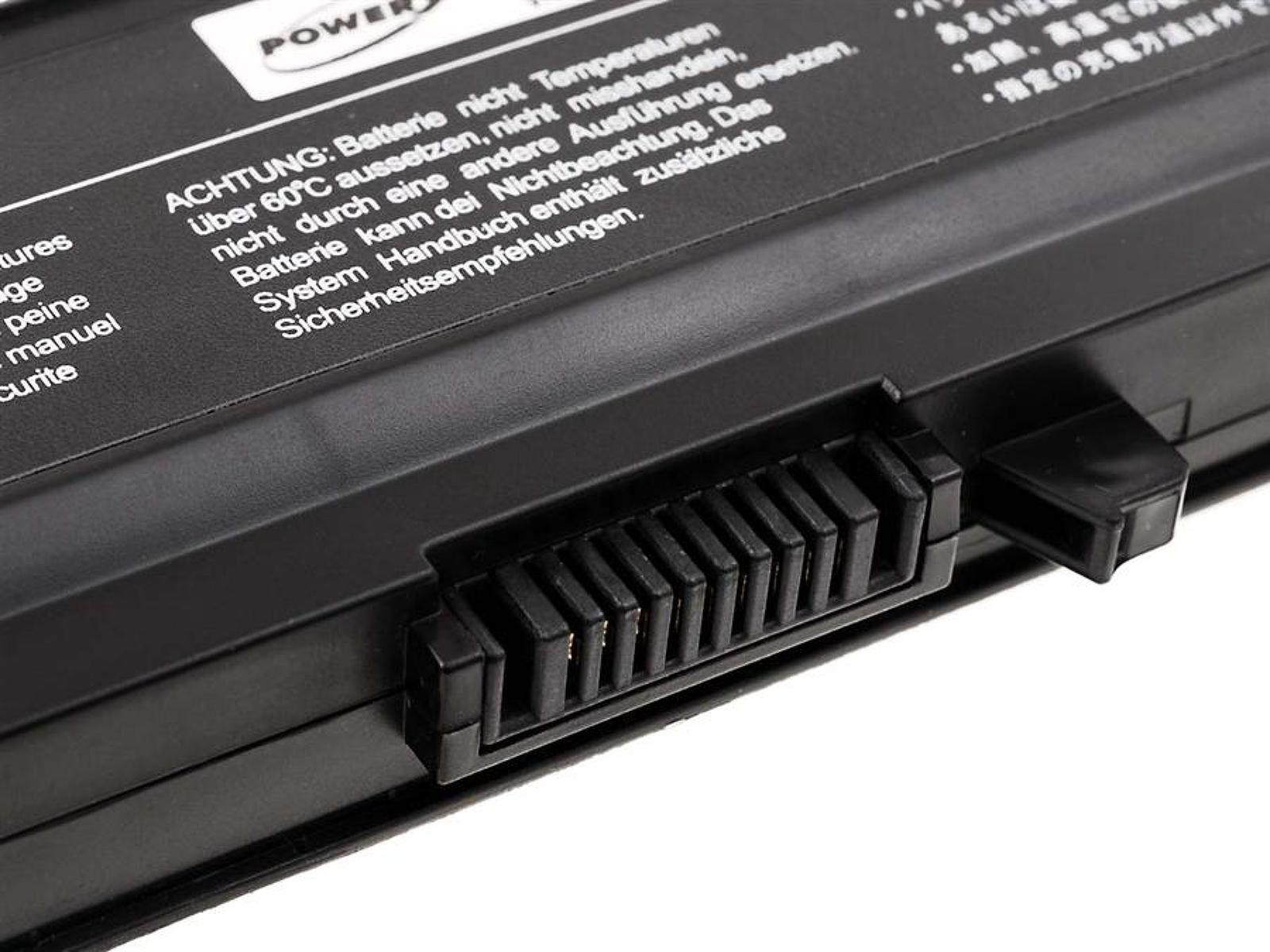 Primer plano de una batería de portátil negra con etiquetas de advertencia y pines de conector.