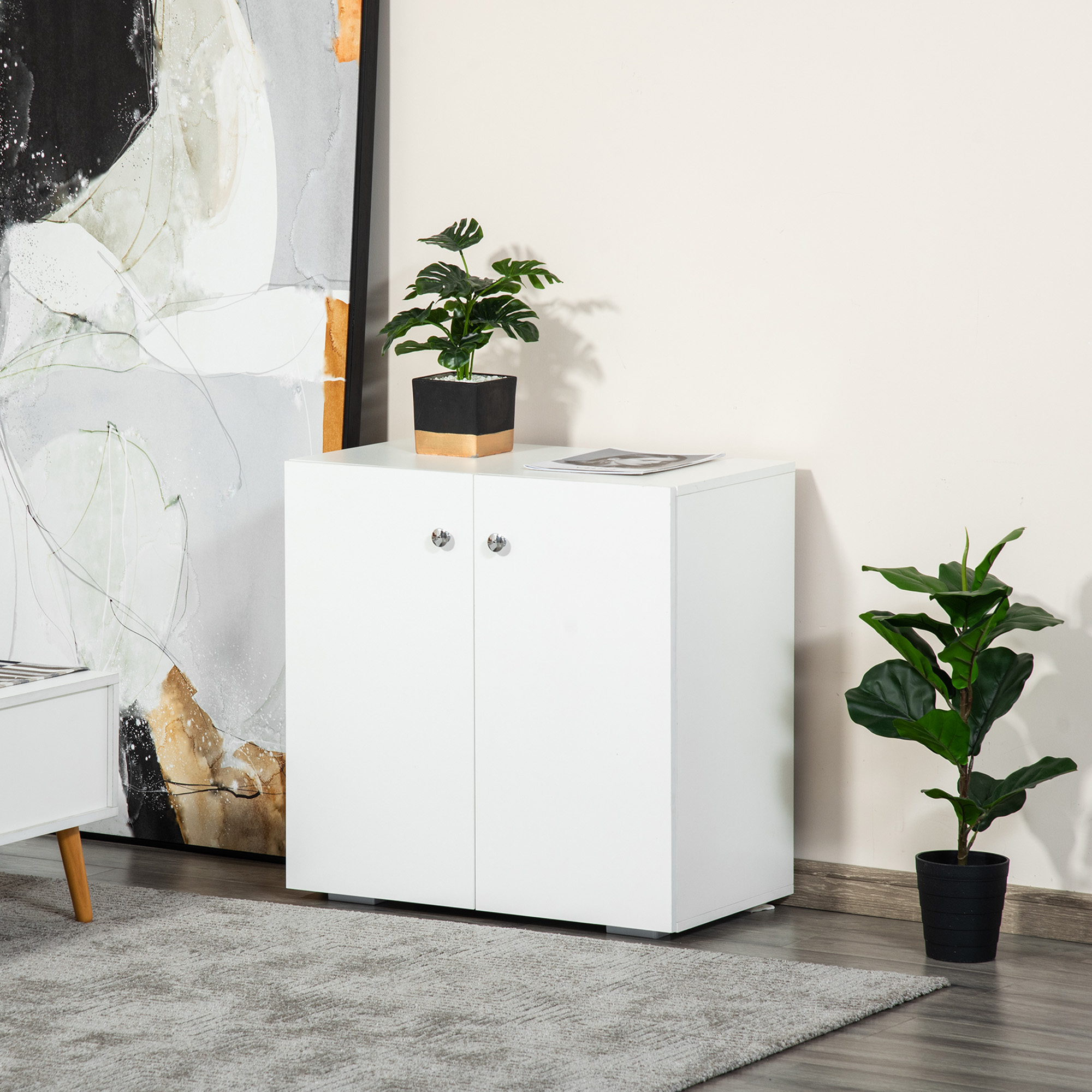 Un armario blanco de dos puertas junto a un cuadro abstracto. Plantas adornan la escena.