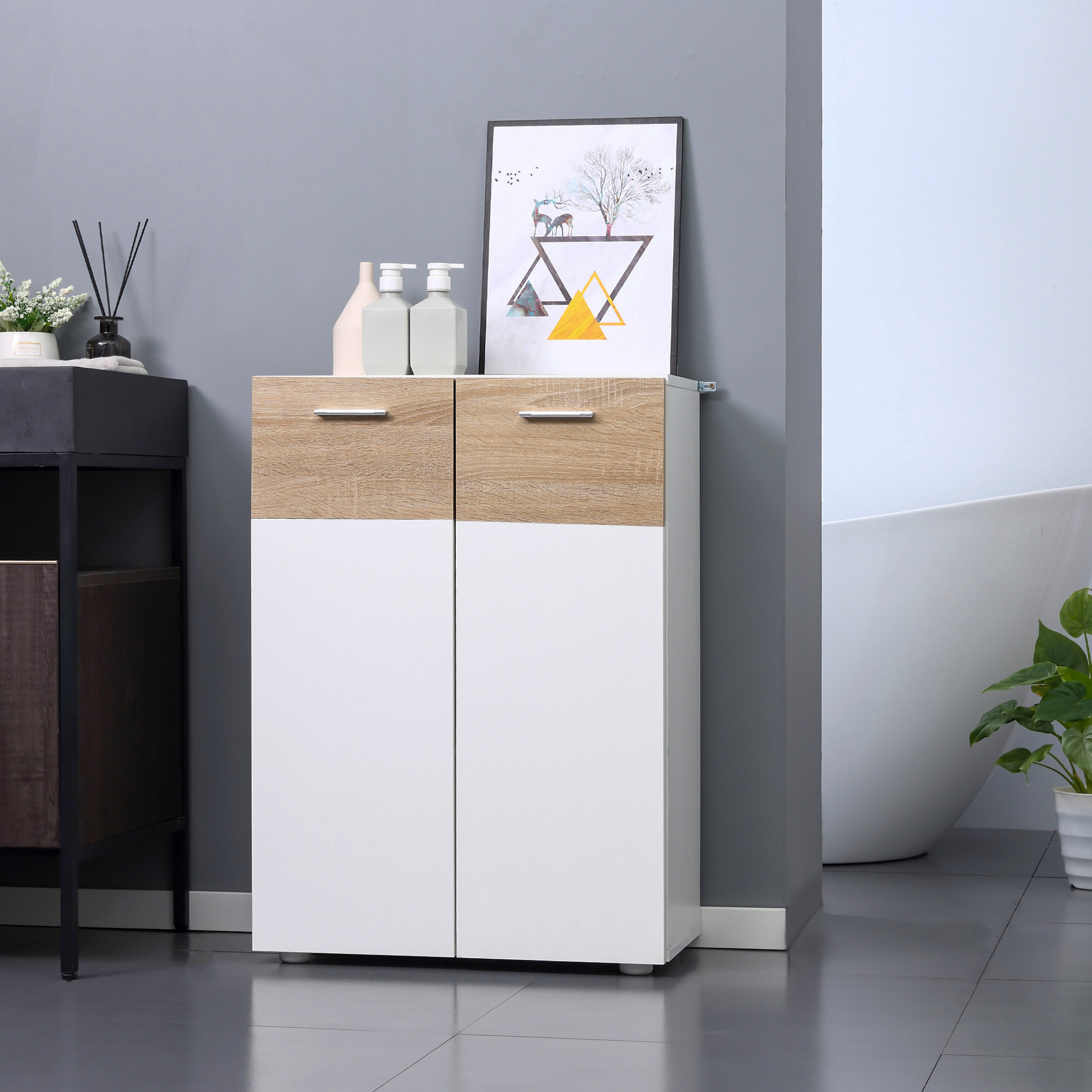 Un armario de madera y blanco con dos puertas junto a una bañera y planta. Un cuadro cuelga encima.