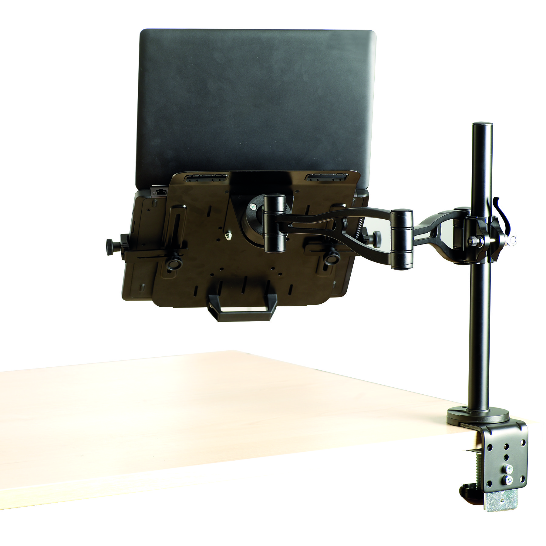 Czarny laptop przymocowany do stojaka na monitorze na jasnym drewnianym biurku.