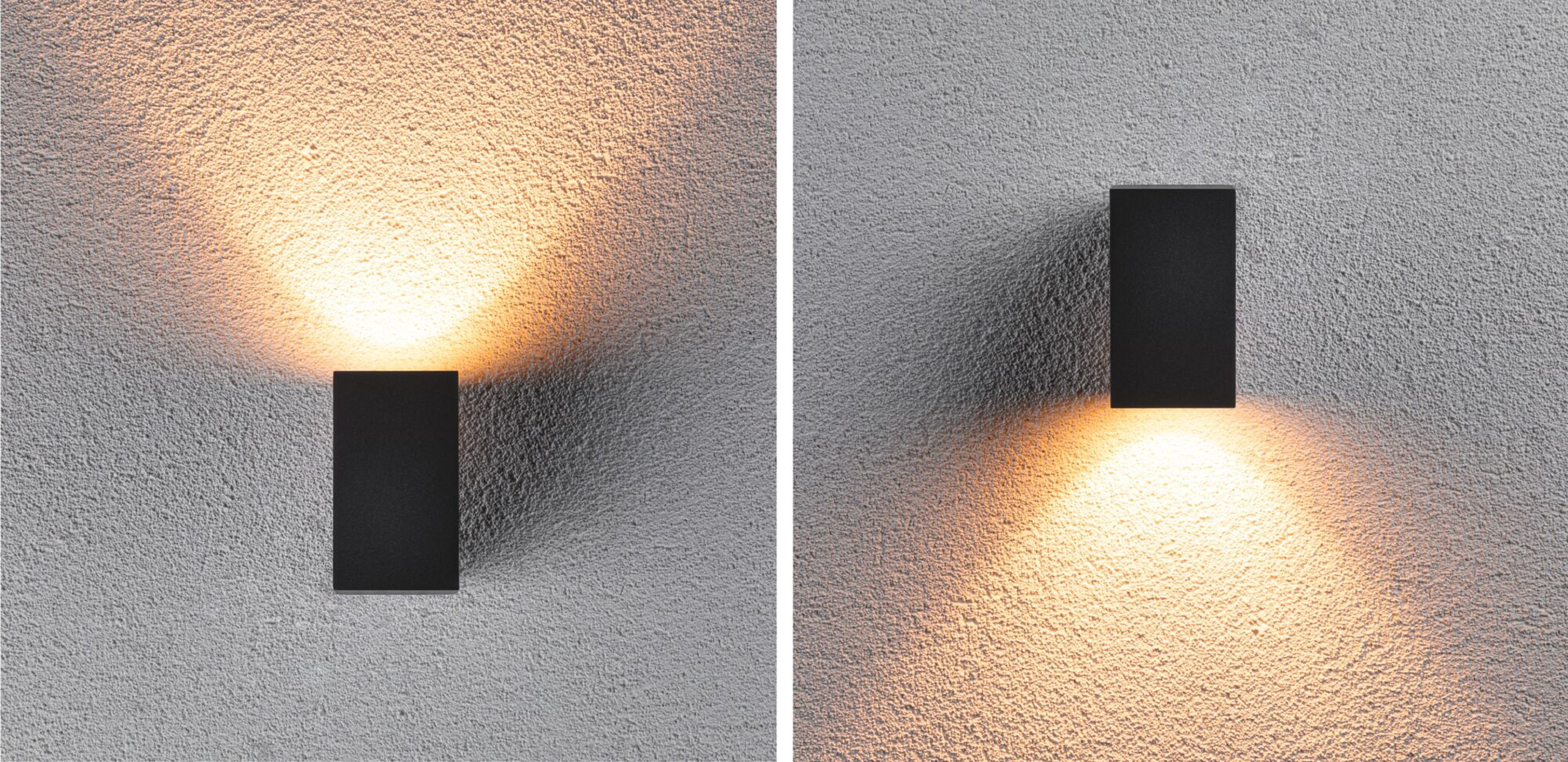 Zwei schwarze Wandlampen an einer strukturierten Wand. Eine ist beleuchtet und wirft Licht. Die andere ist aus.